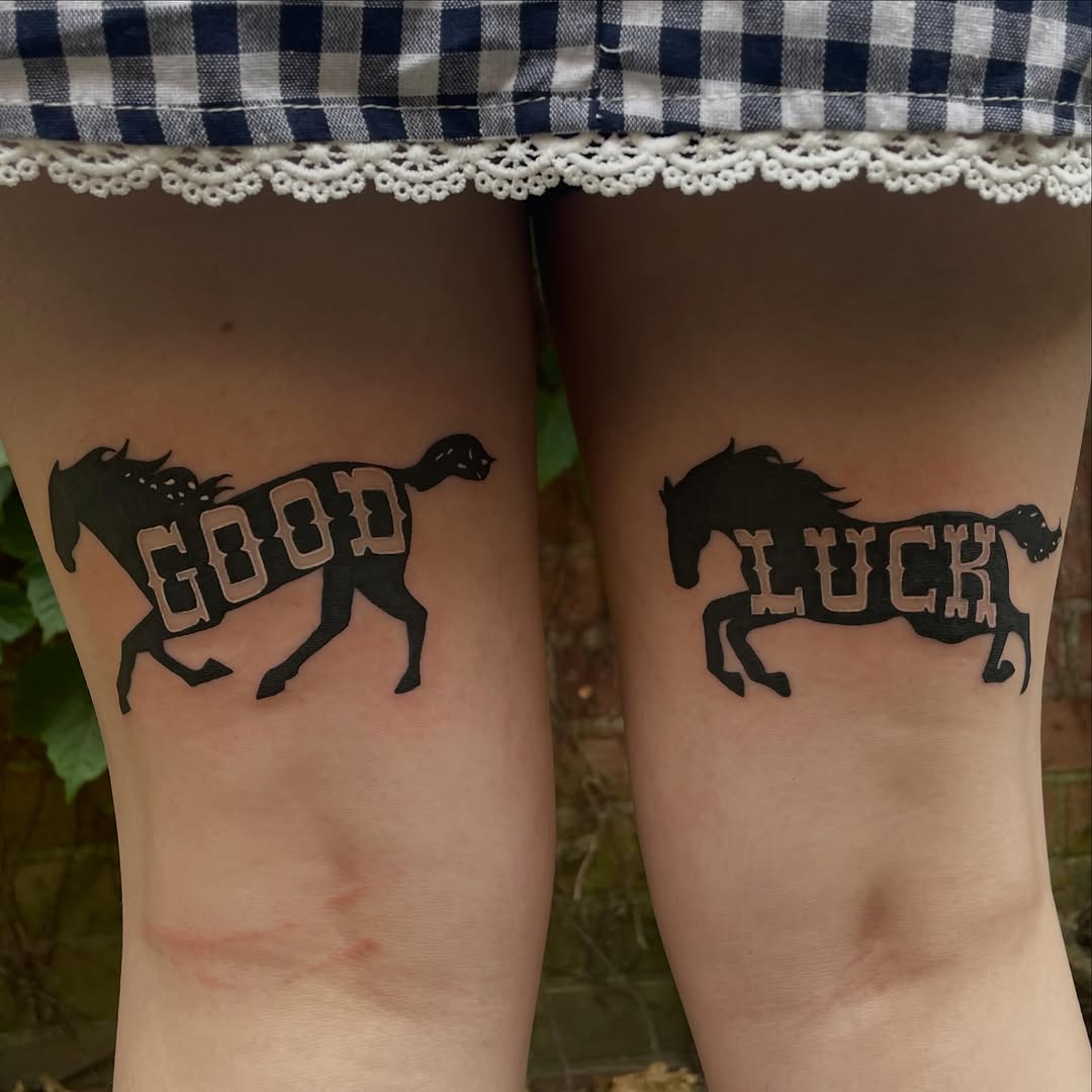 Horses with text realism tattoo on the thigh by Avalon Sable