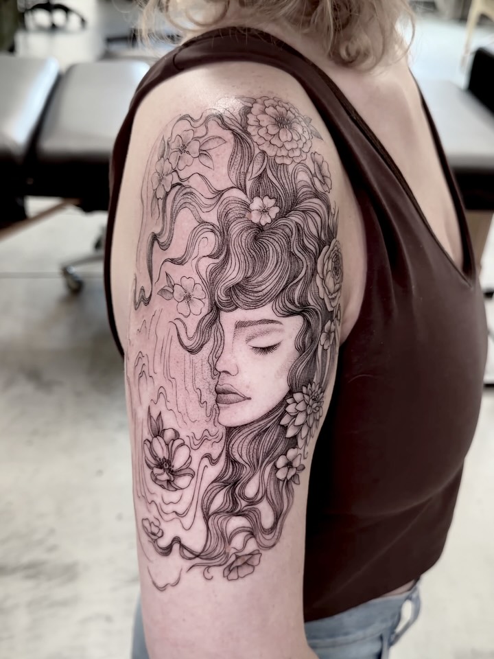 Woman with flowers realism tattoo on the shoulder by Anna