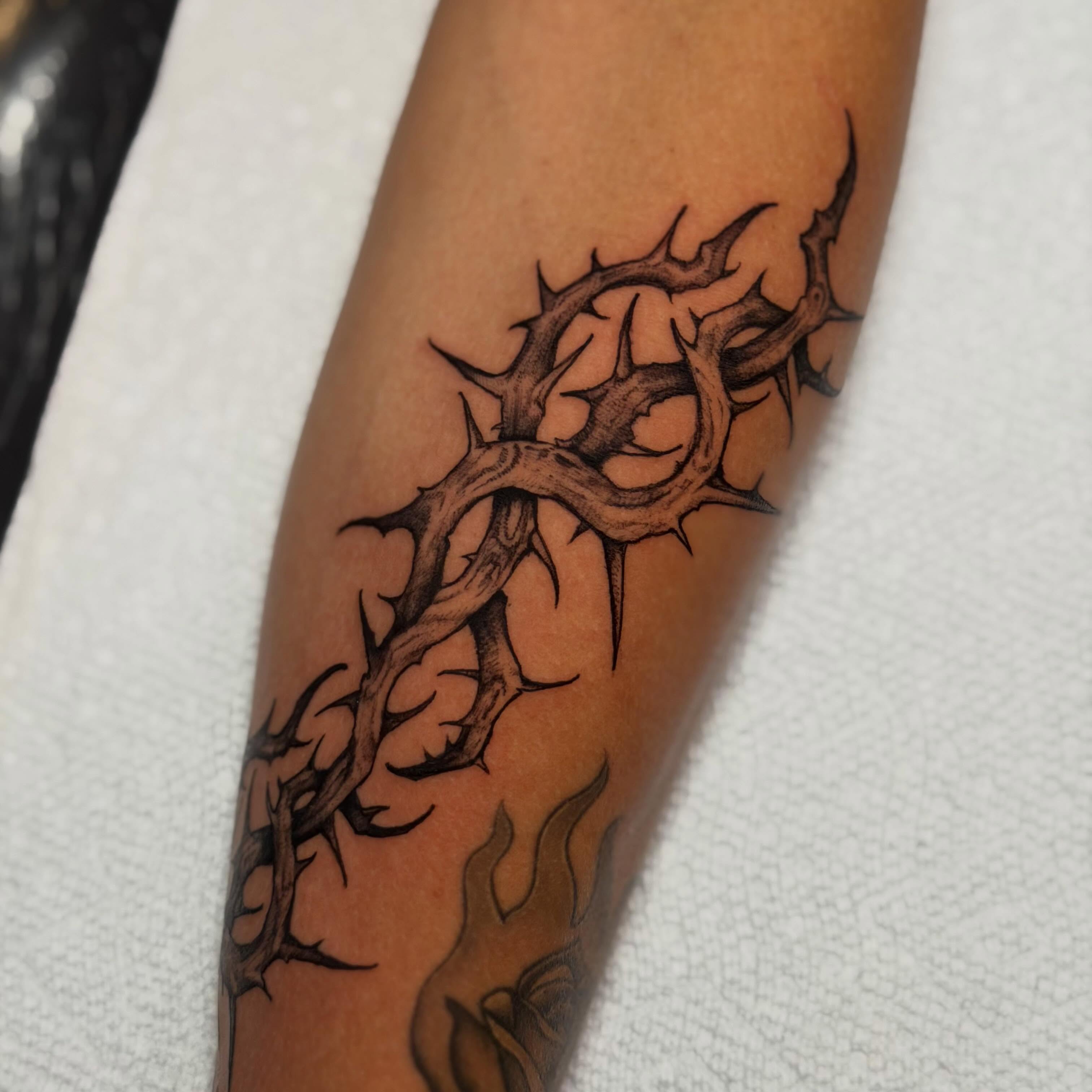 Thorn crown black and grey tattoo on the forearm by Adam Newton