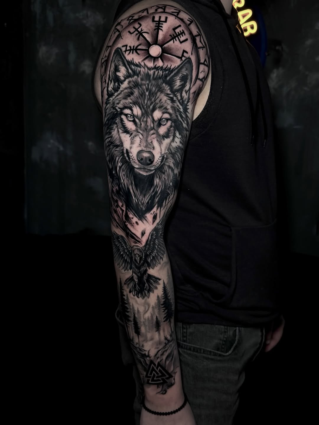 Wolf, raven, and viking symbols realism tattoo on the forearm by Keyla Valdes, Miami, Florida
