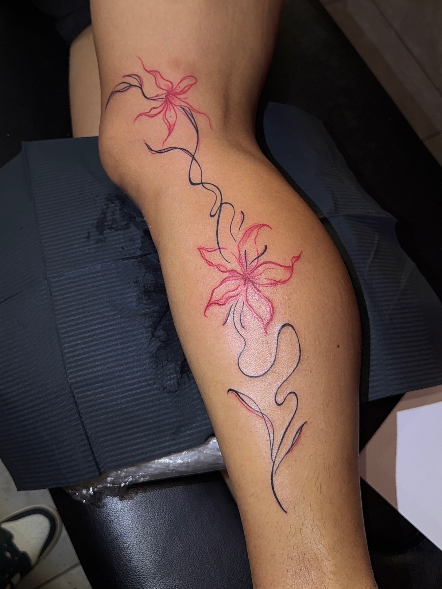Lily new school tattoo on the thigh by XoticTherapy, Las Vegas, Nevada