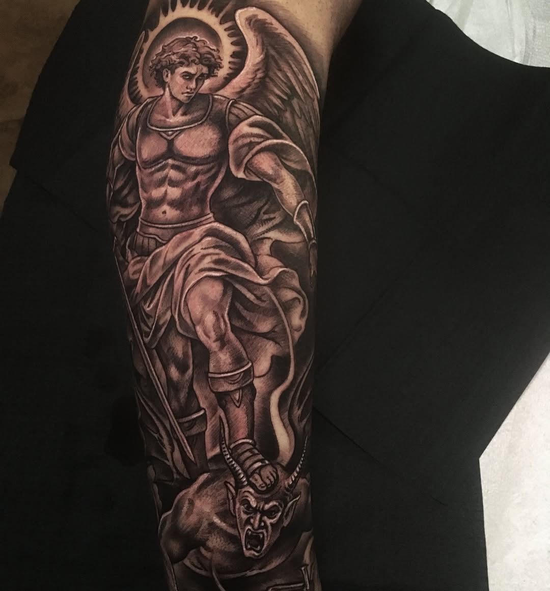 Archangel Michael defeating a demon realism tattoo on the forearm by Jose Calderon