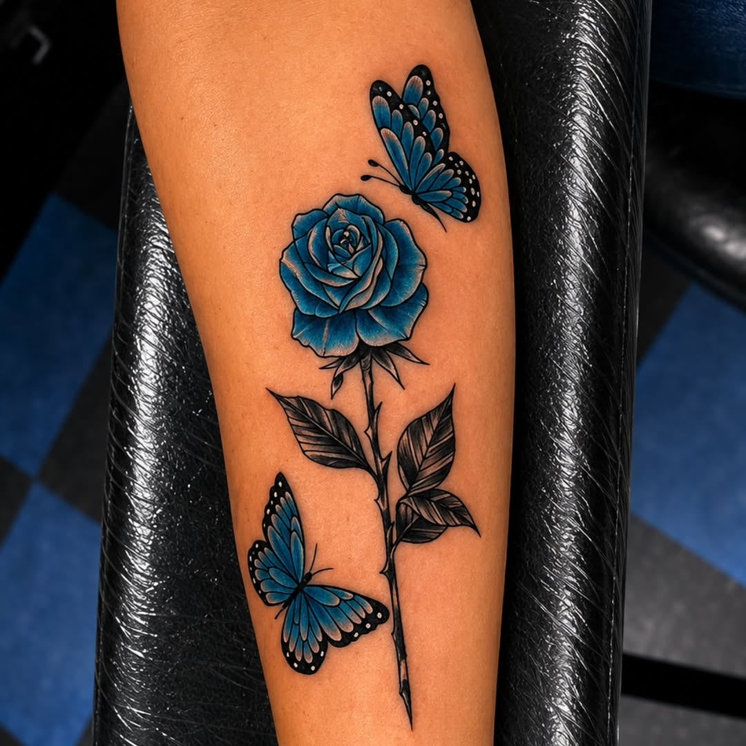 Blue rose and butterflies neo-traditional tattoo on the forearm by Kai_Tattoo
