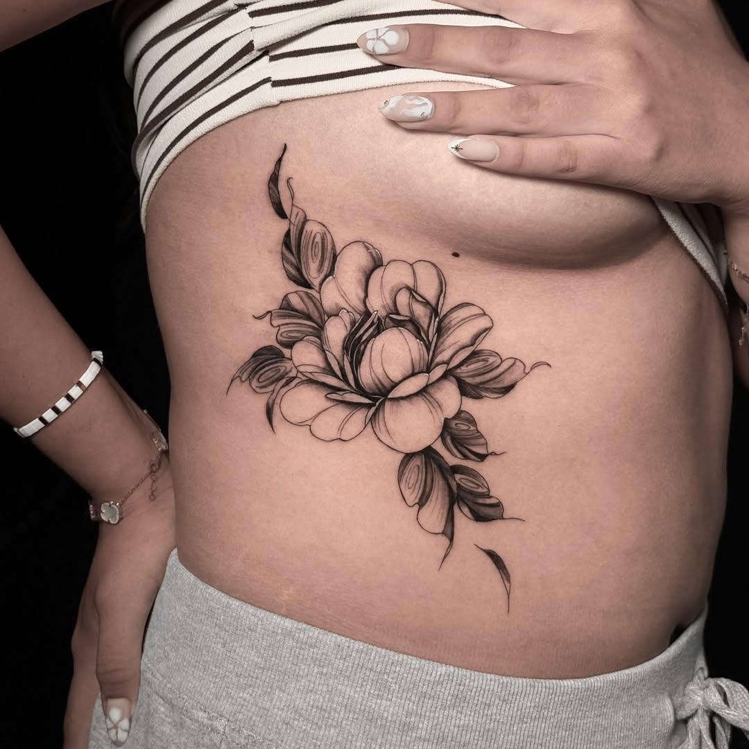 Peony flower fine line tattoo on the ribs by Alex Cantor
