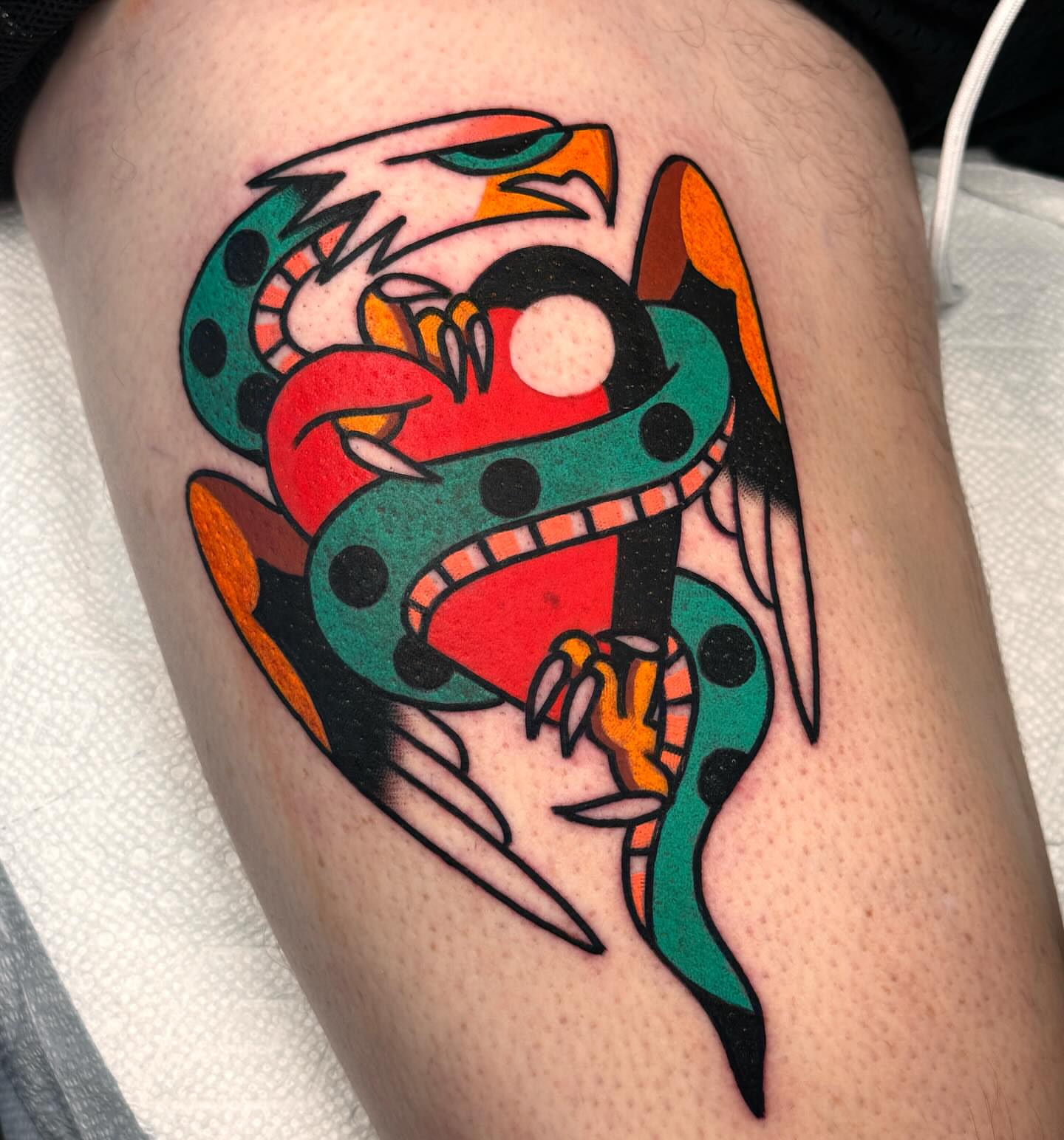 Snake American traditional tattoo on the thigh by Jess Baker
