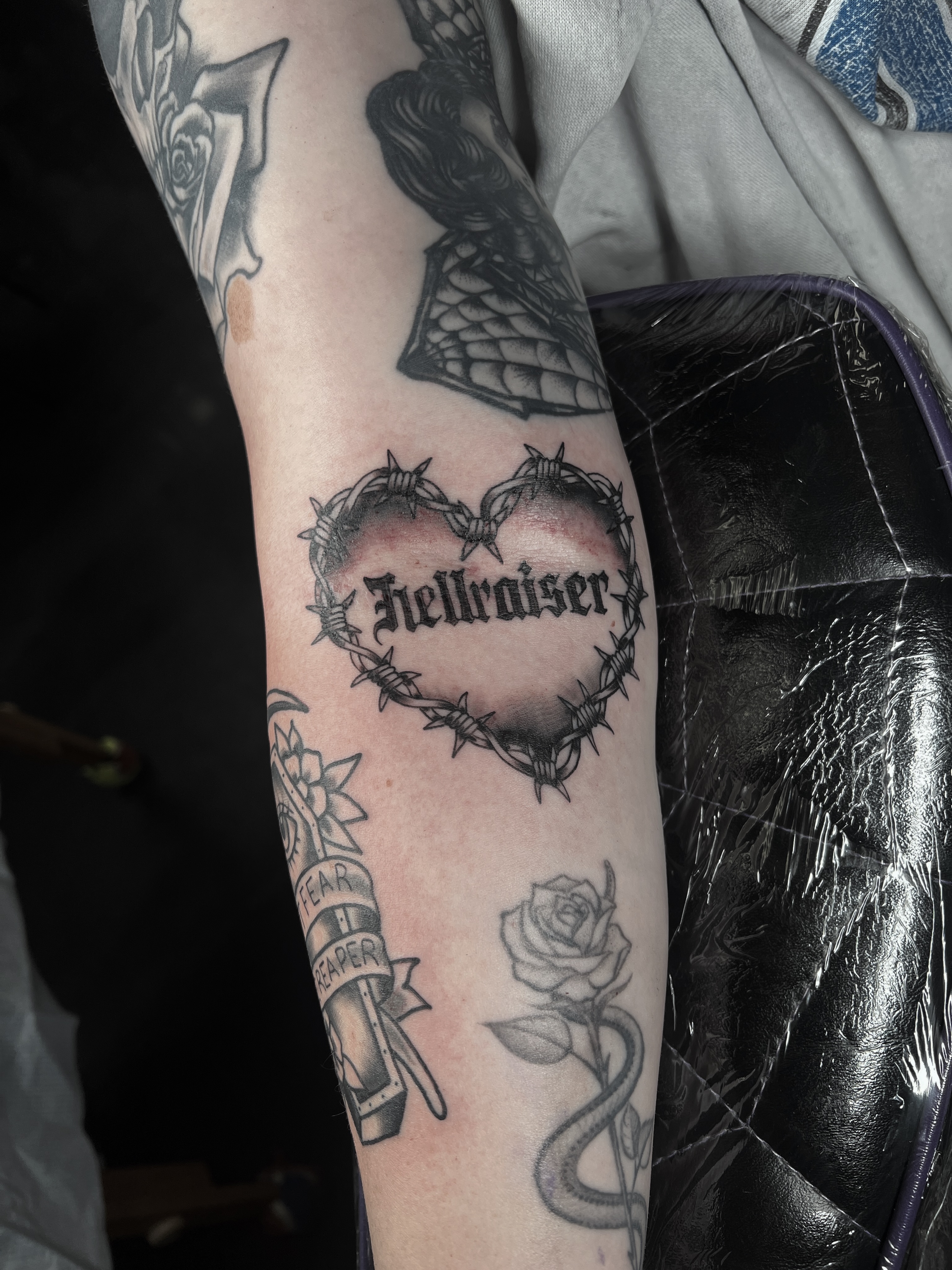 Barbed heart black and grey tattoo on the forearm by Brian Mock