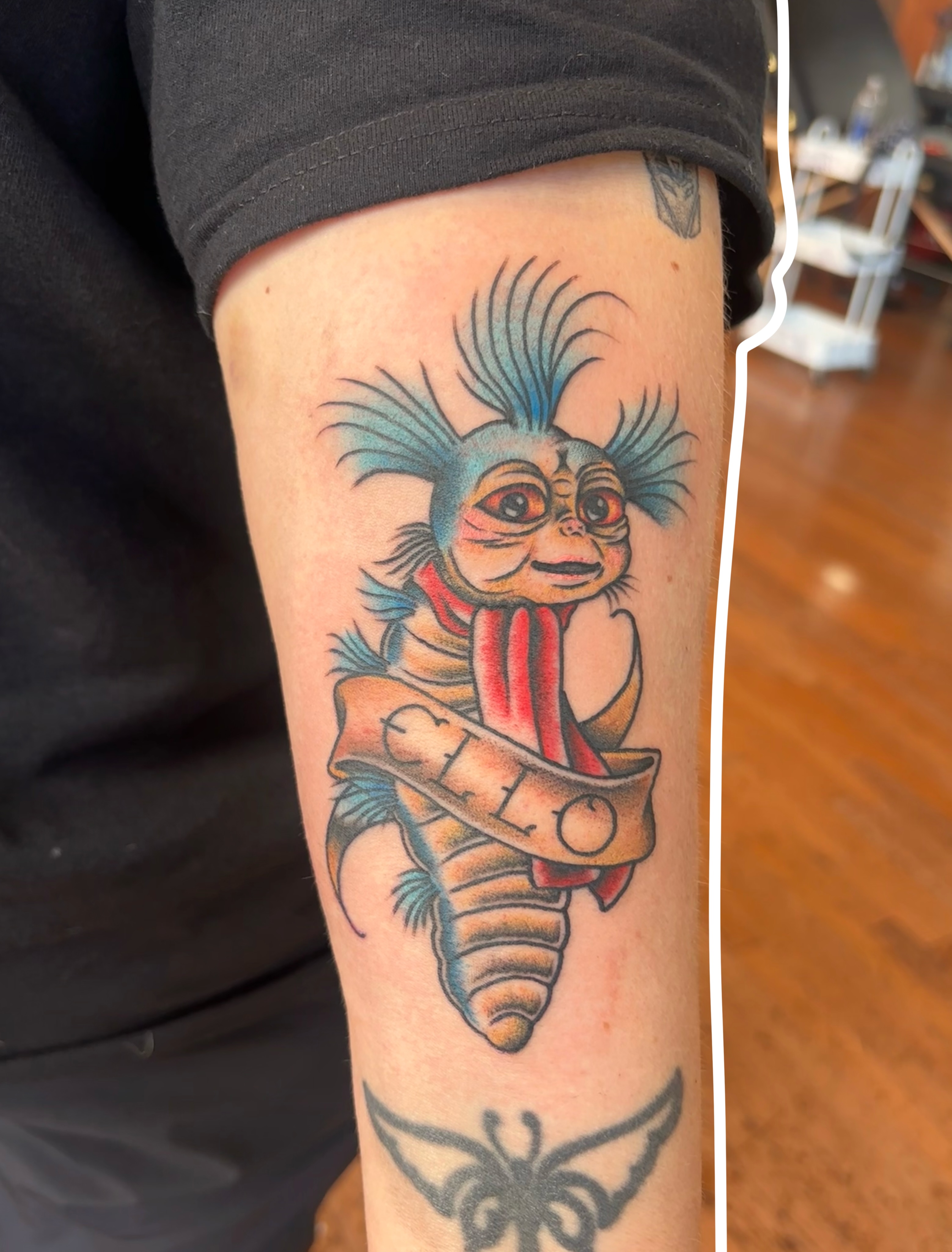 Chucky American traditional tattoo on the forearm by Emmy Stepien