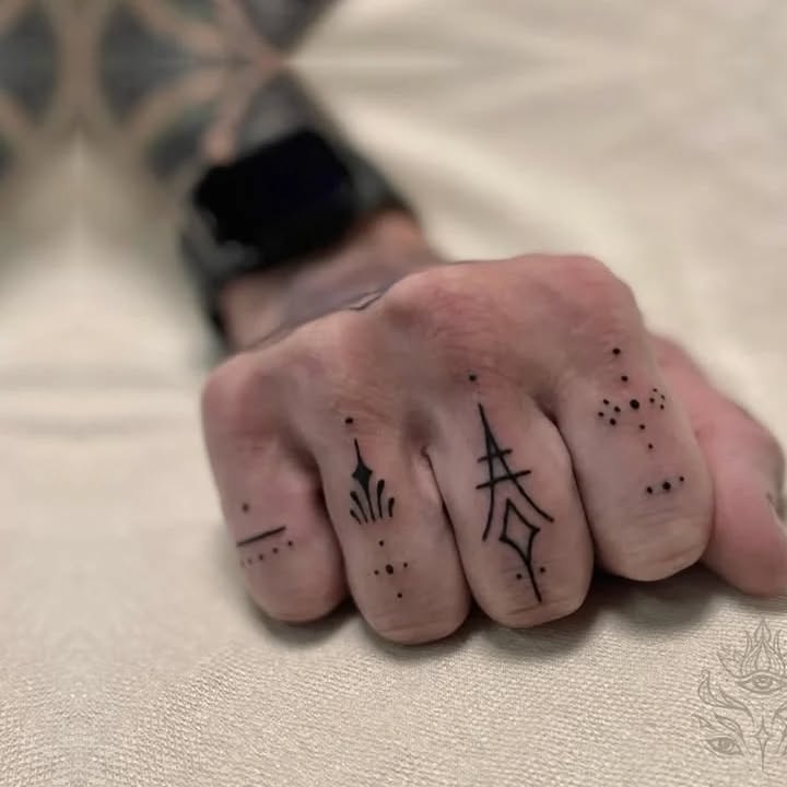 Geometric designs on fingers ornamental tattoo on the hand by Donavon Batz