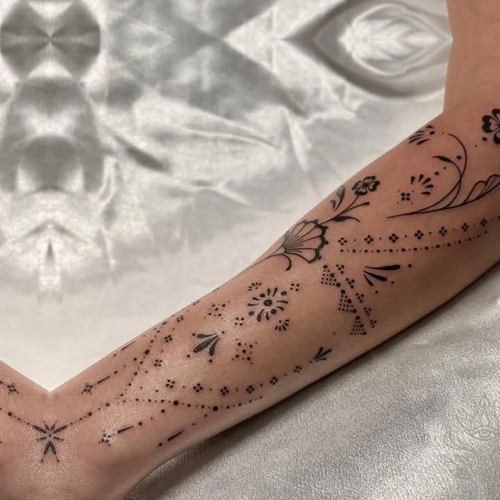 Floral and geometric pattern ornamental tattoo on the forearm by Donavon Batz