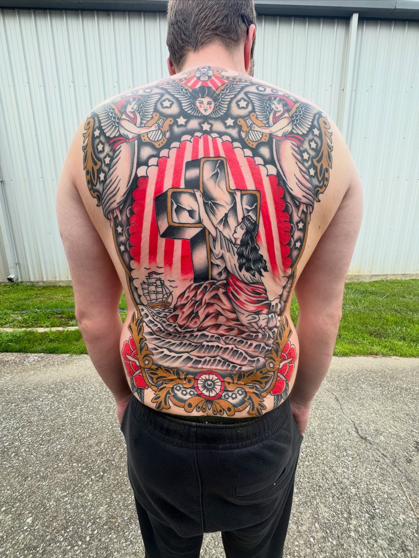Religious crucifixion scene American traditional tattoo on the back by Kenneth Gibson