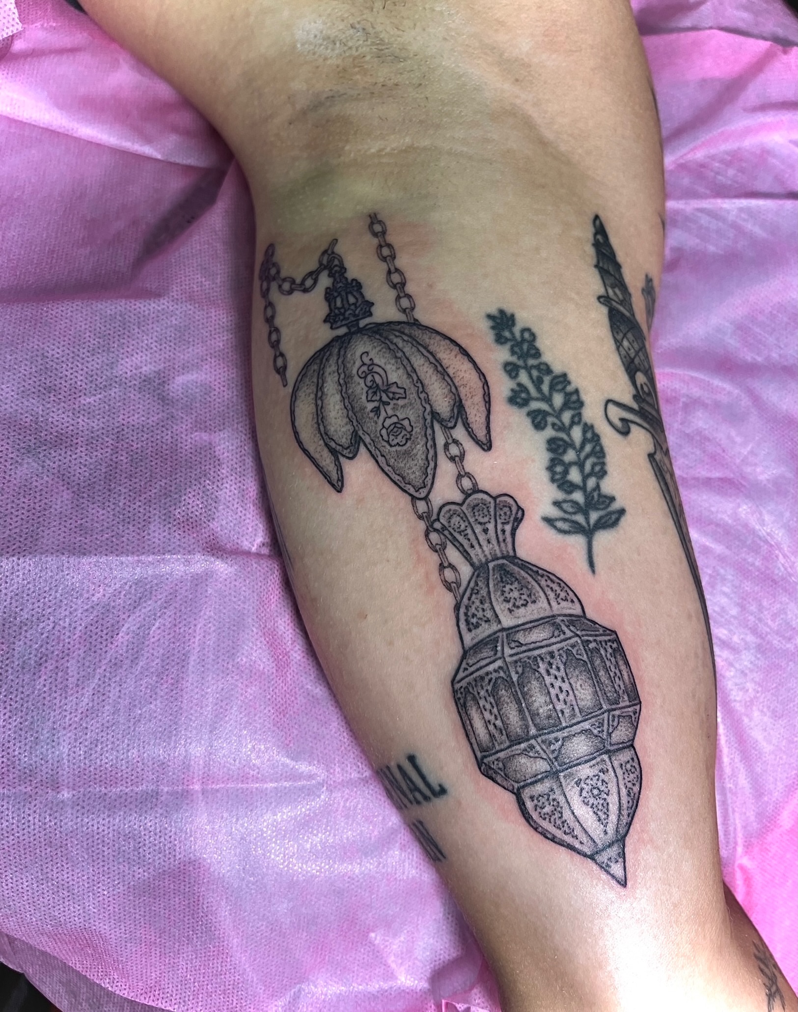 Lamp and plant black and grey tattoo on the forearm by Bri Leflore