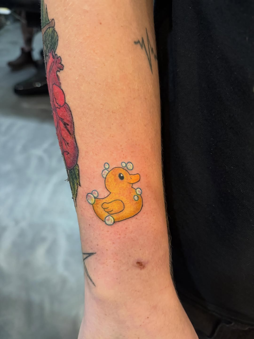 Rubber ducky with bubbles new school tattoo on the forearm by Kai