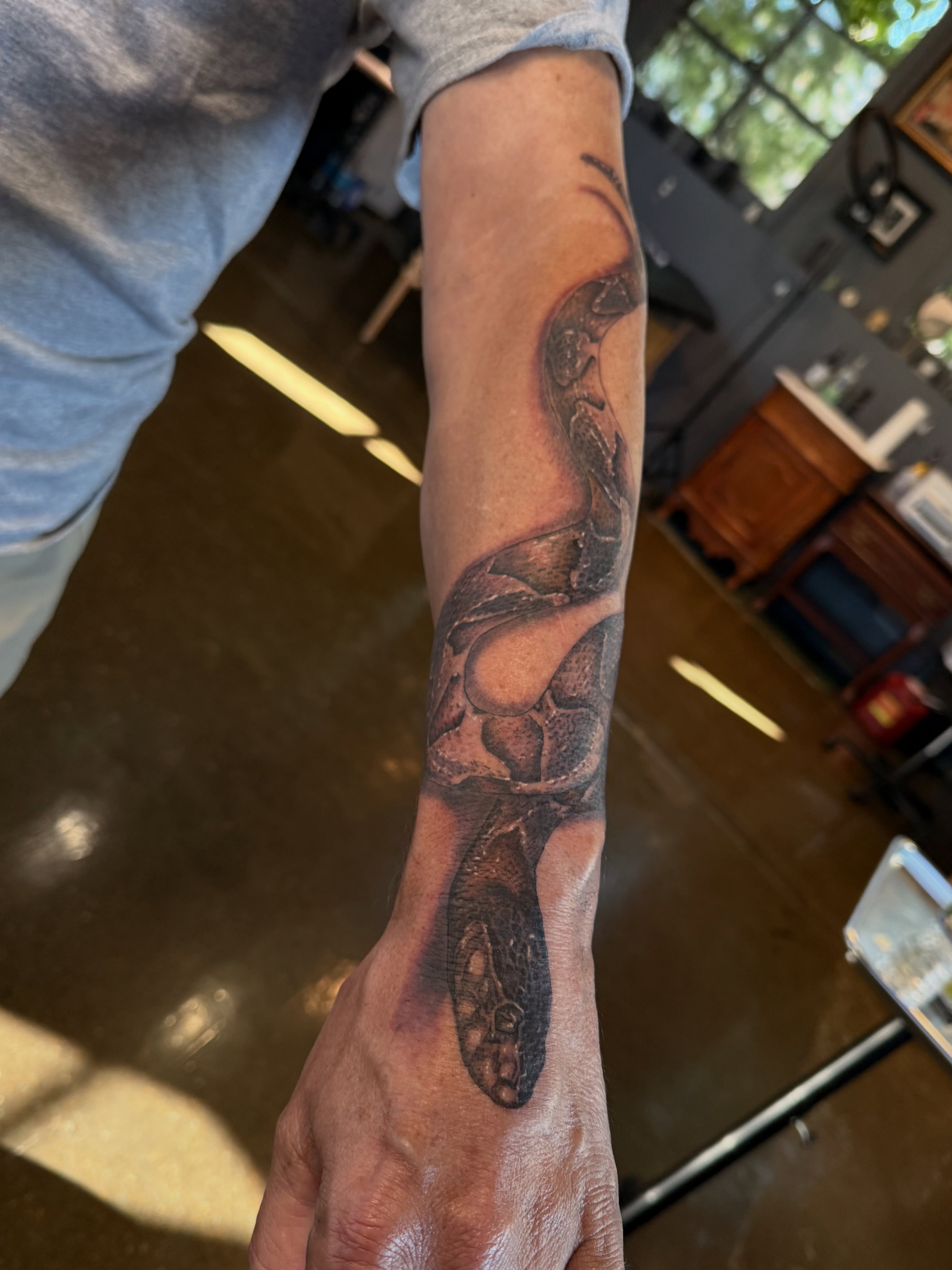 Snake realism tattoo on the forearm by Miles Haysmith