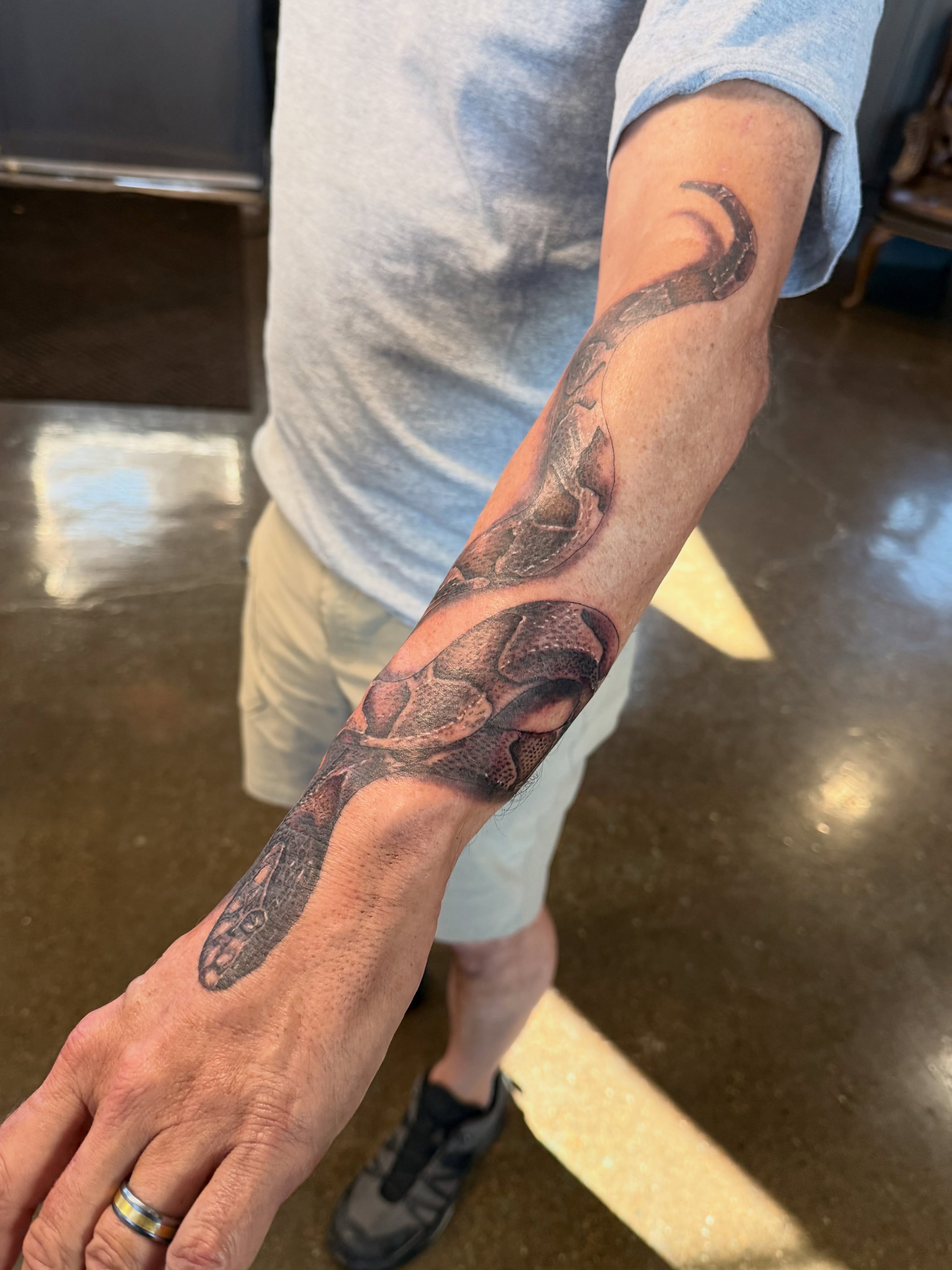 Snake realism tattoo on the forearm by Miles Haysmith