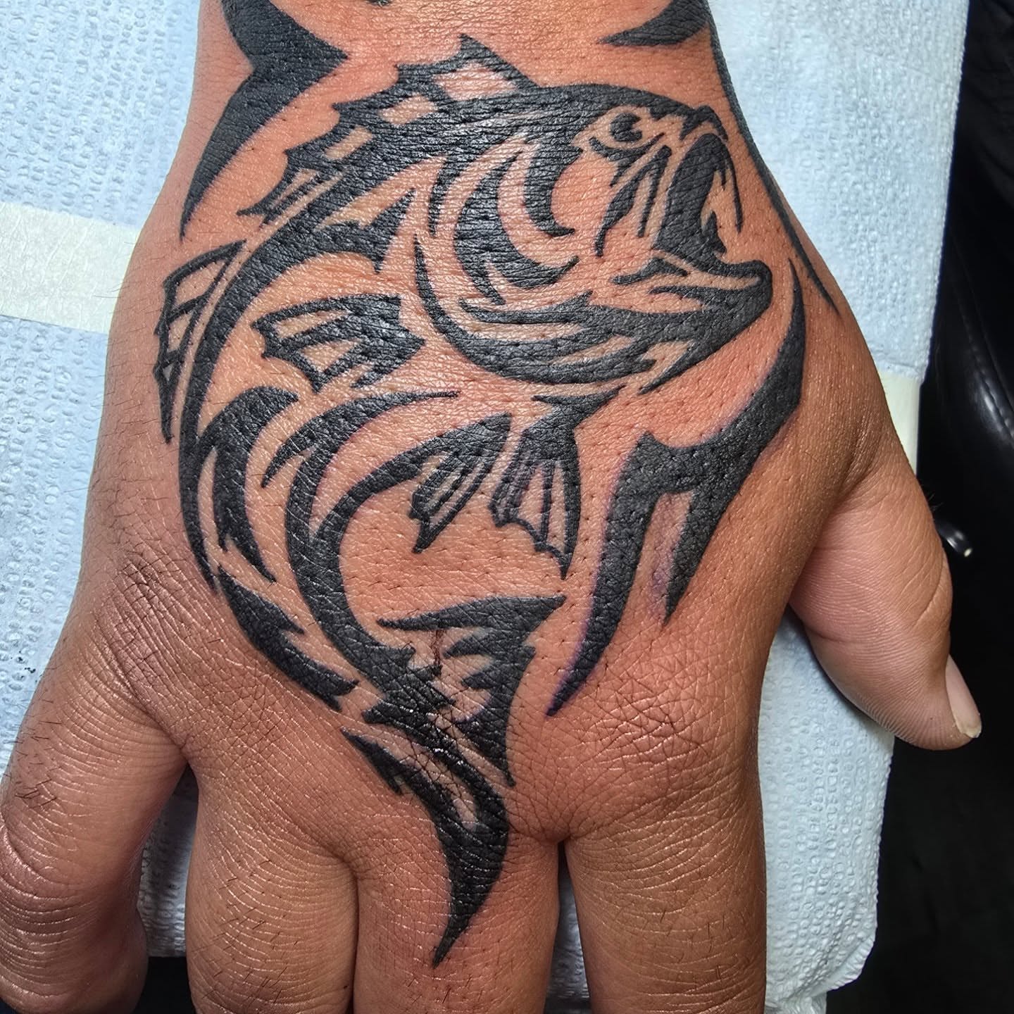 Fish tribal tattoo on the hand by bonnie