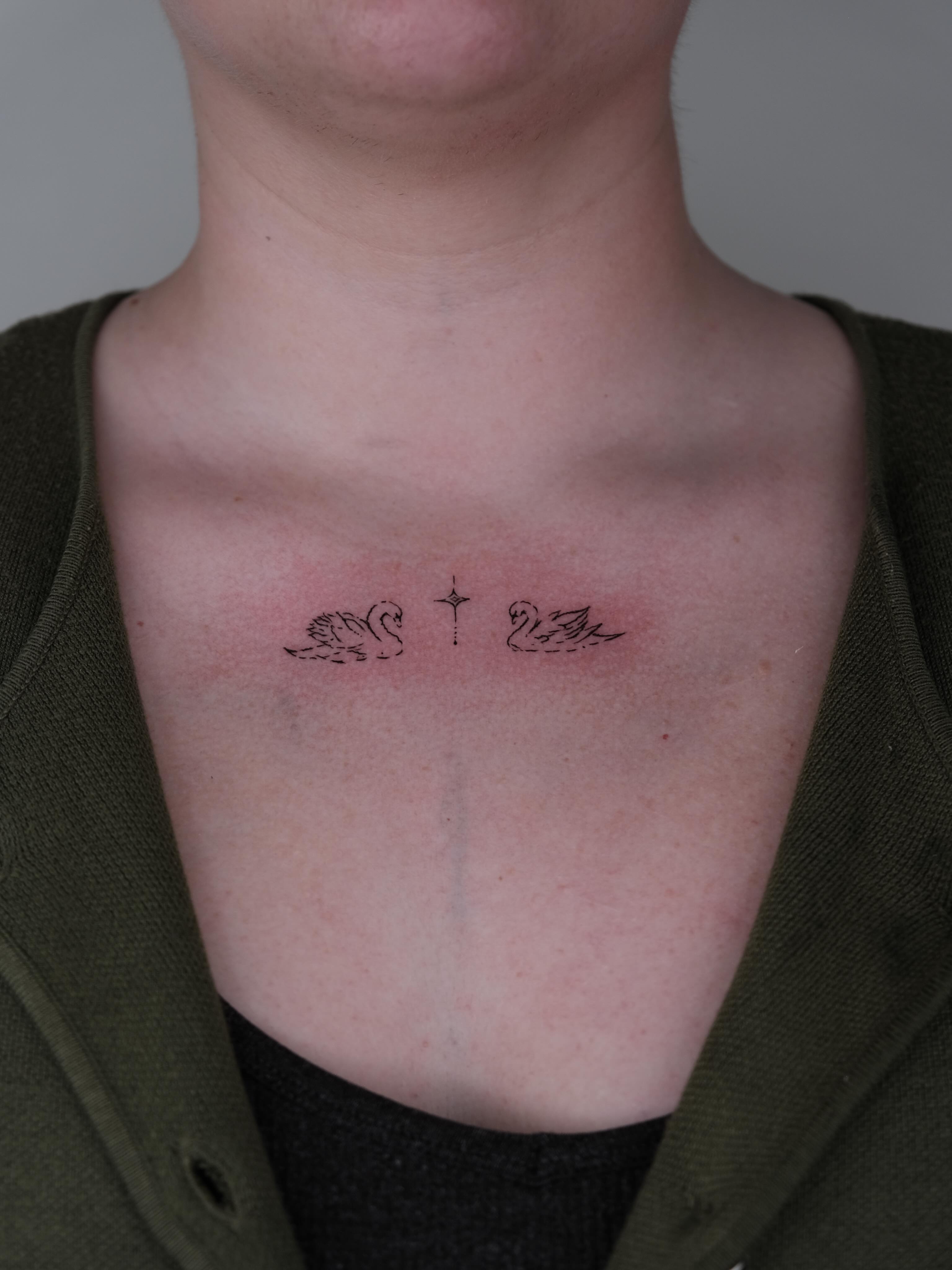 Swans black and grey tattoo on the chest by Elana Hites
