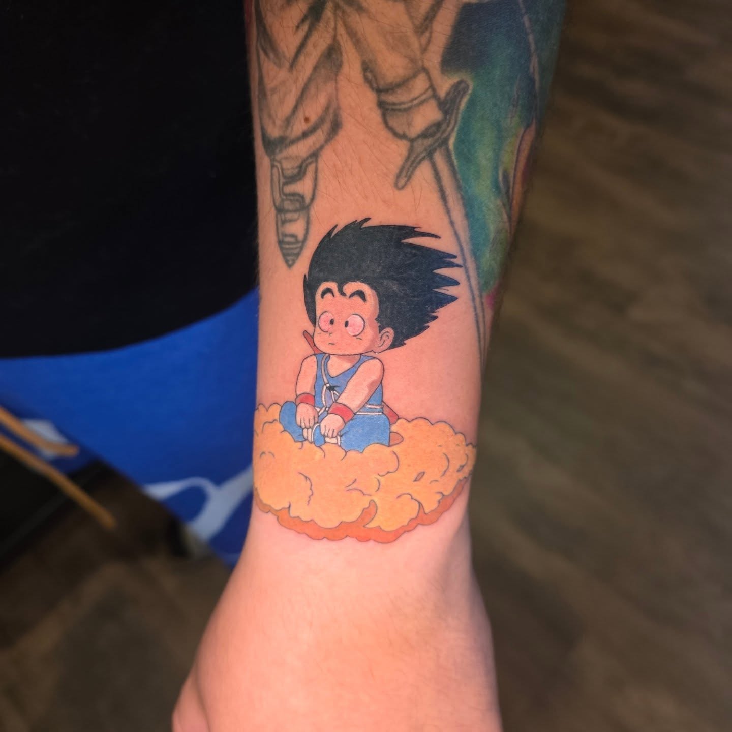 Goku on cloud anime tattoo on the forearm by Maggie