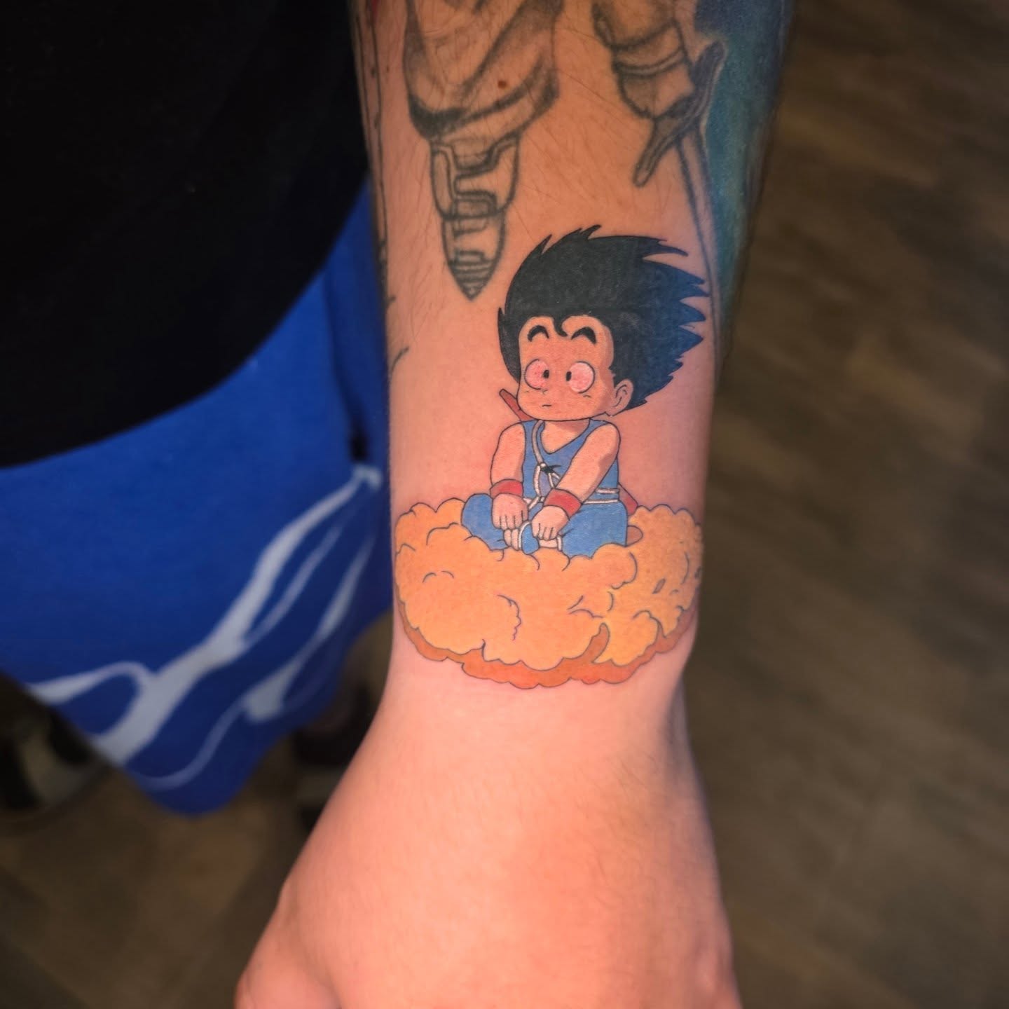 Goku on cloud anime tattoo on the forearm by Maggie