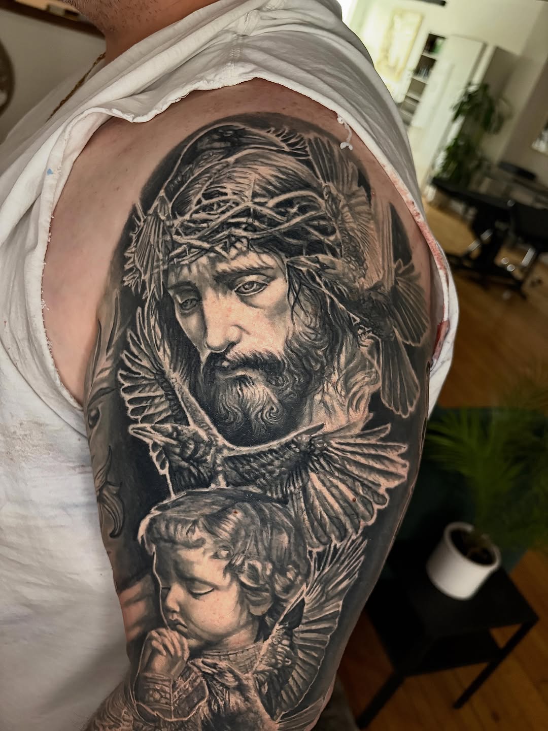 Jesus and cherub with birds realism tattoo on the shoulder by Jacee Hamilton