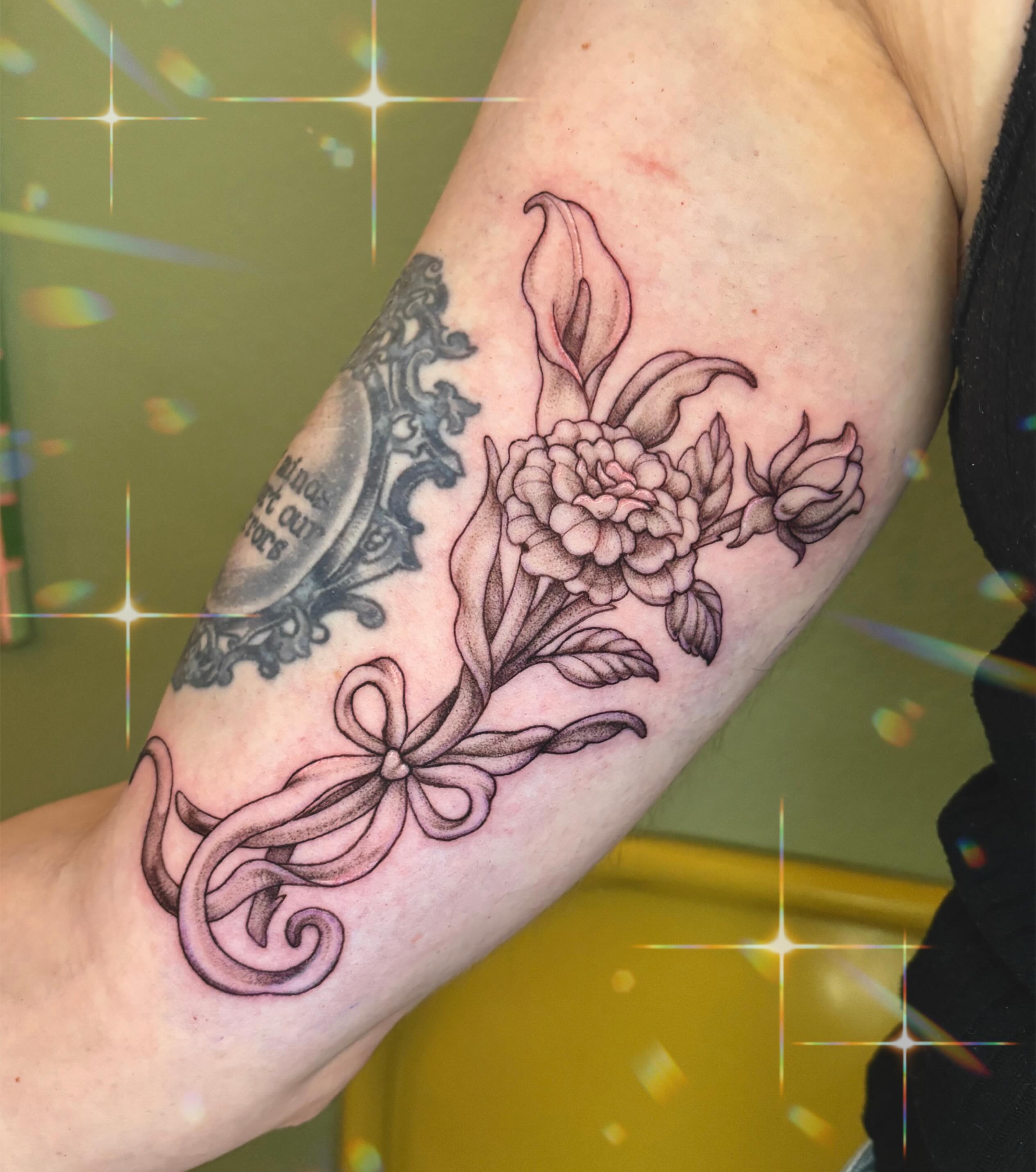 Peony and ribbon black and grey tattoo on the forearm by Autumn