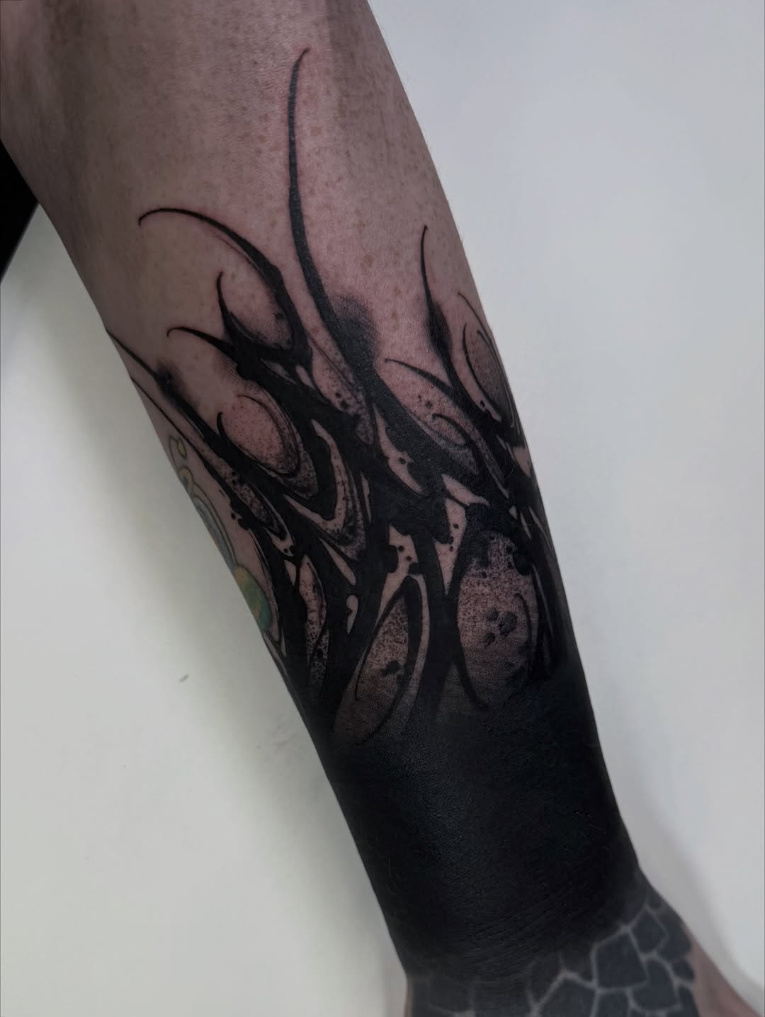 Abstract black ink blackwork tattoo on the forearm by S C A B B e R W O C K y