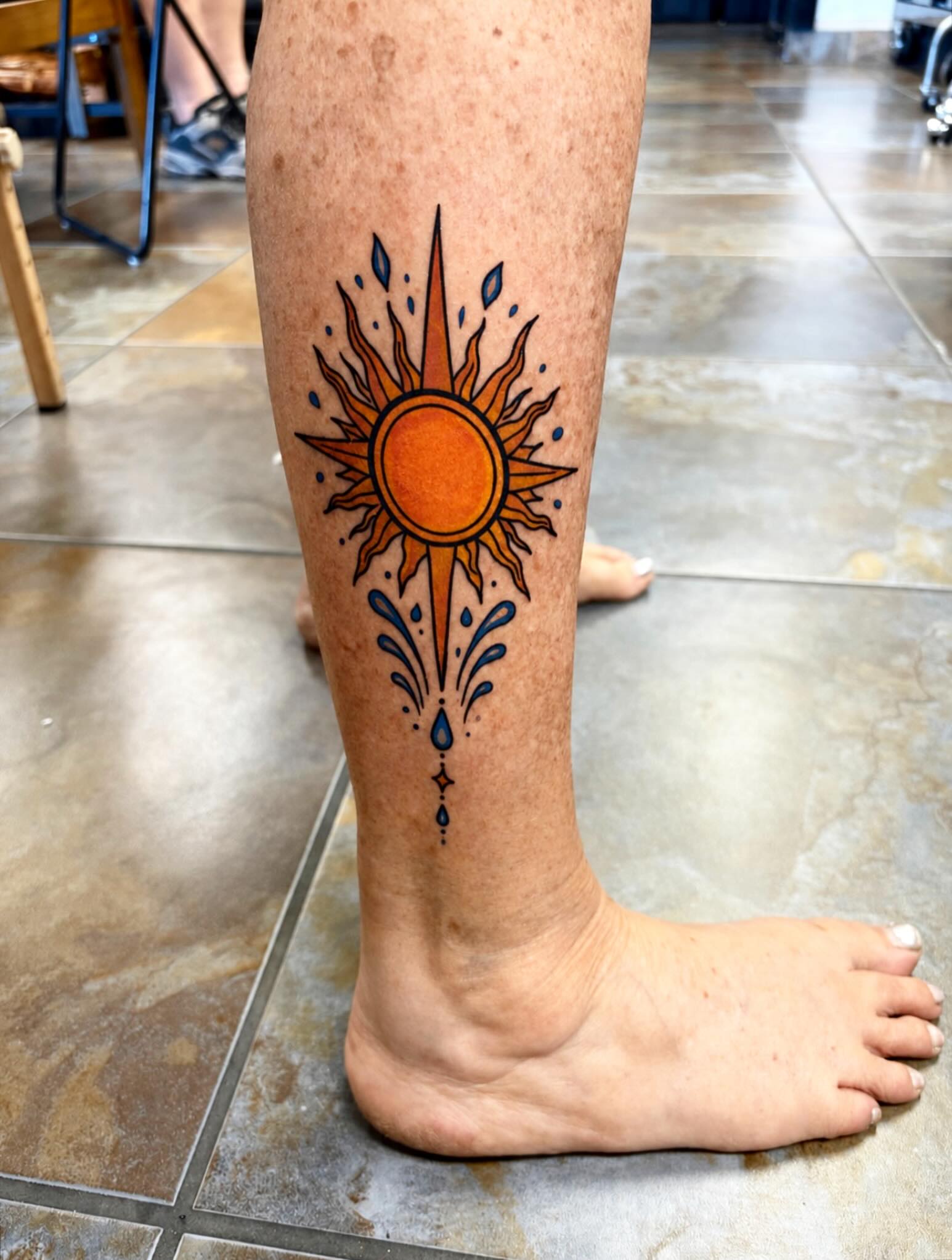 Sun dotwork tattoo on the calf by Stoney