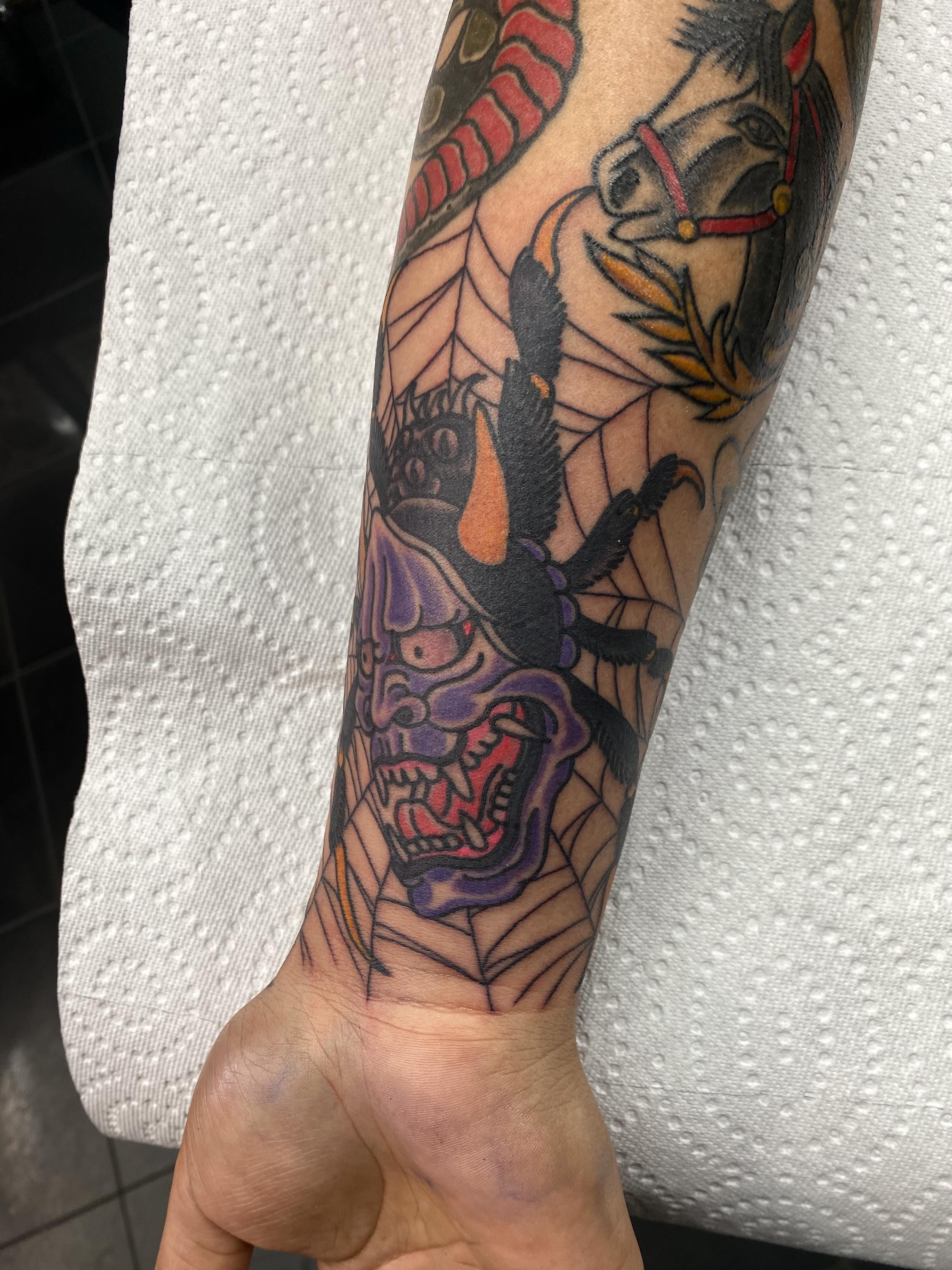Demon mask American traditional tattoo on the forearm by Houston tattoo artist