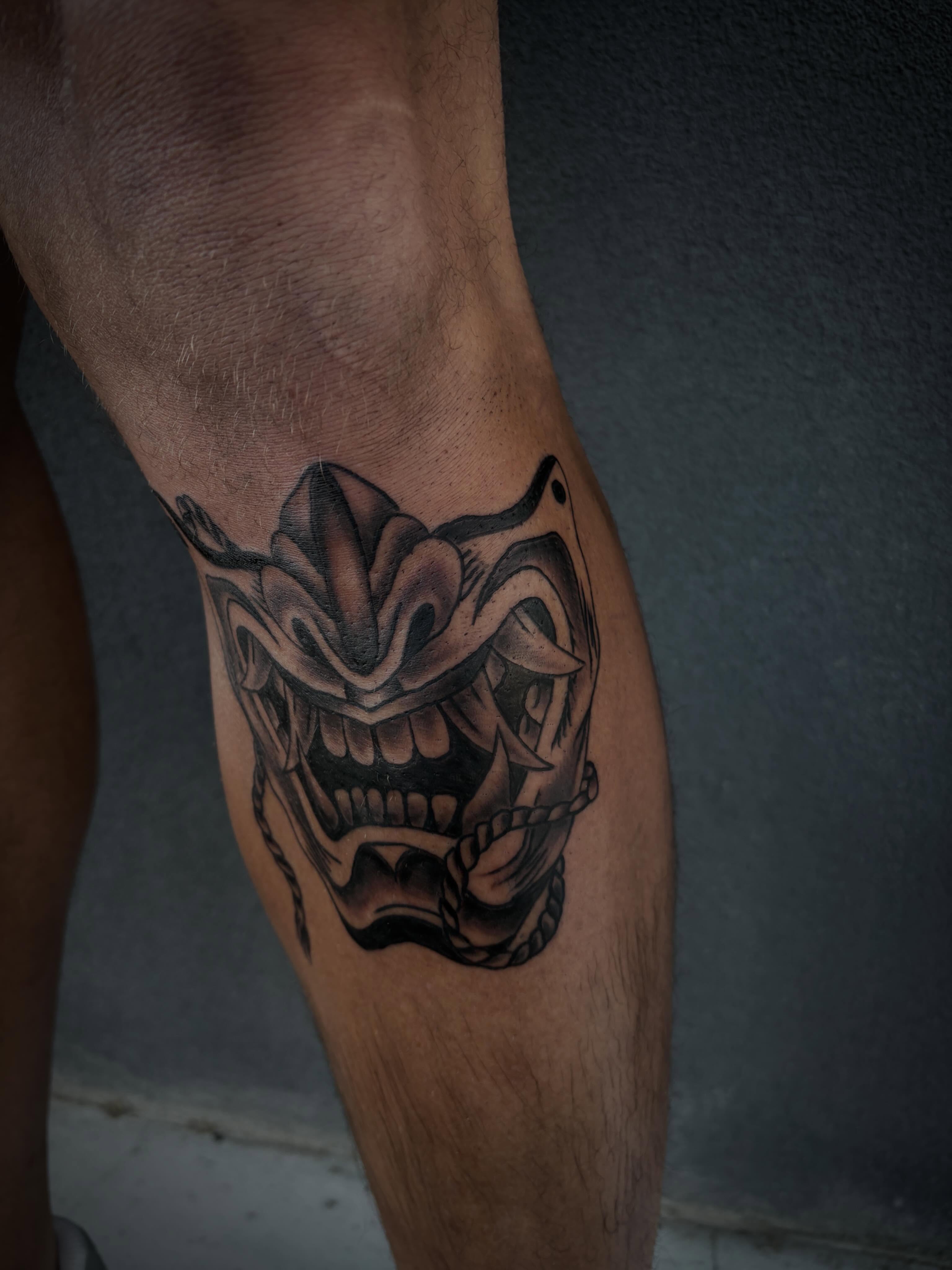 Jester mask black and grey tattoo on the leg by Tattoo Artist Lilliann:)