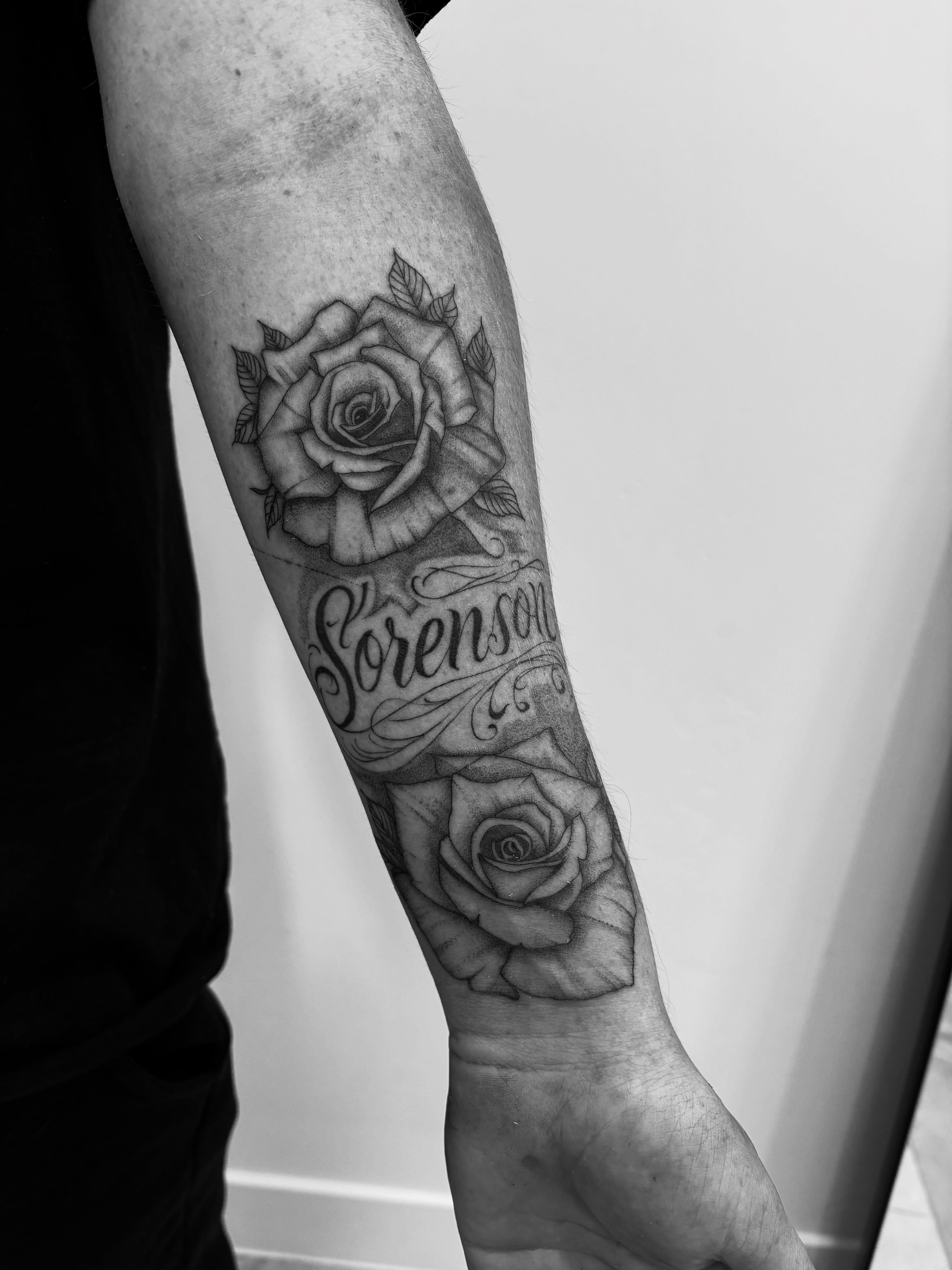 Rose and name black and grey tattoo on the forearm by Tayler, Tooele, Utah