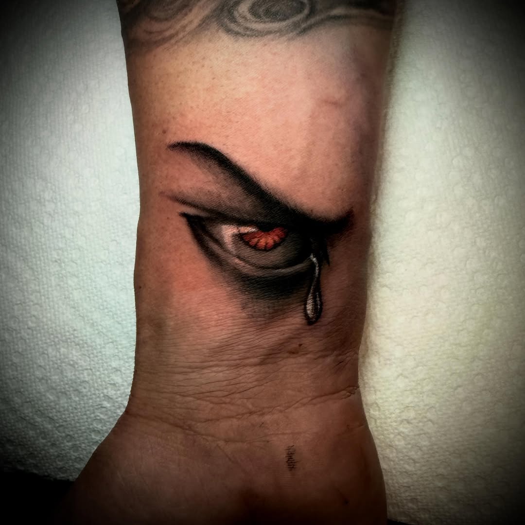 Crying eye realism tattoo on the forearm by Jameson William Cowan