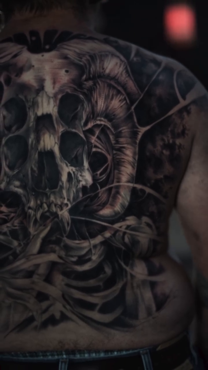 Ram skull and ribcage dark realism tattoo by Daniel Gonzalez