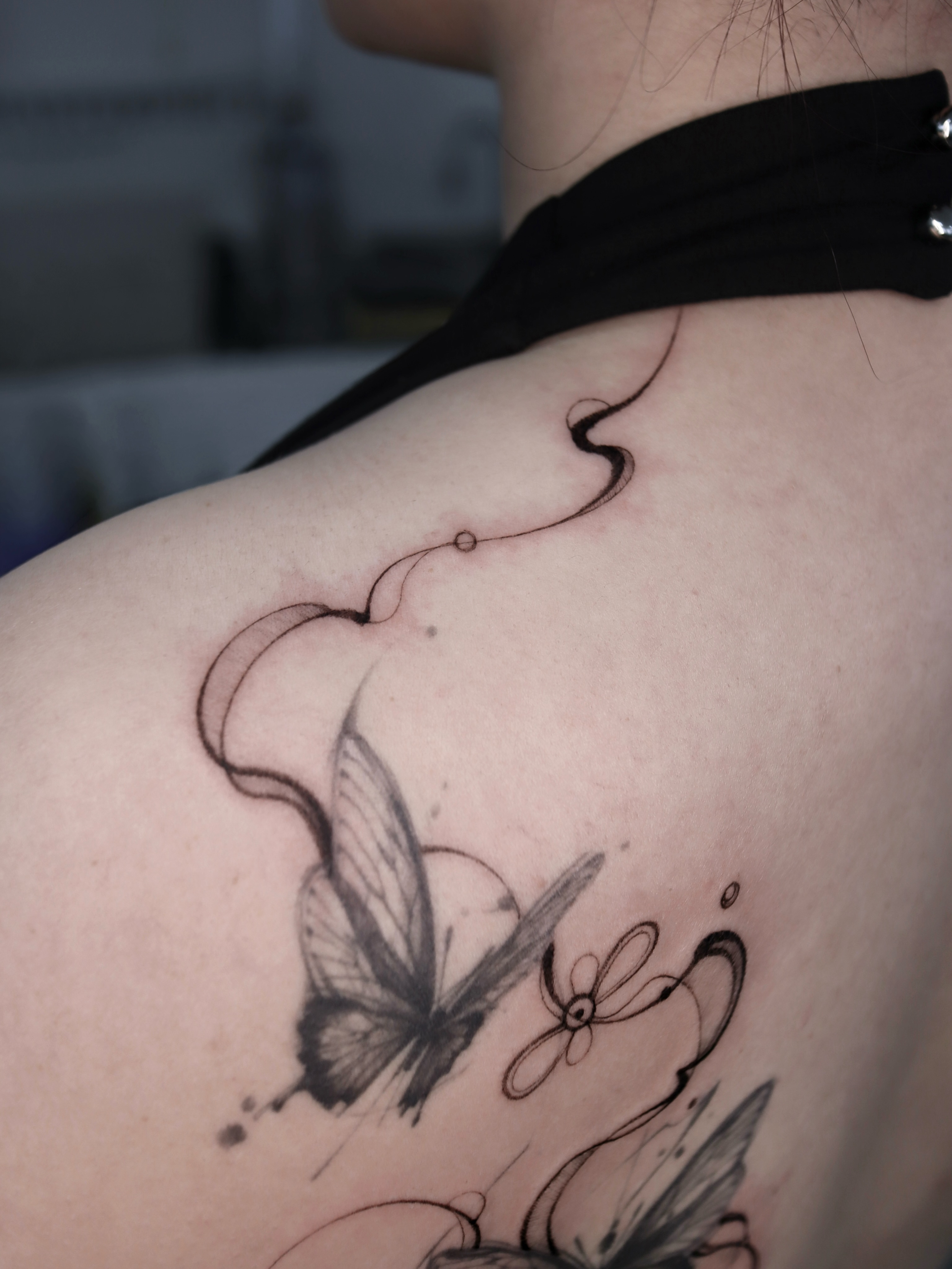 Butterfly and flower black and grey tattoo on the shoulder by @tattoo_chamsae