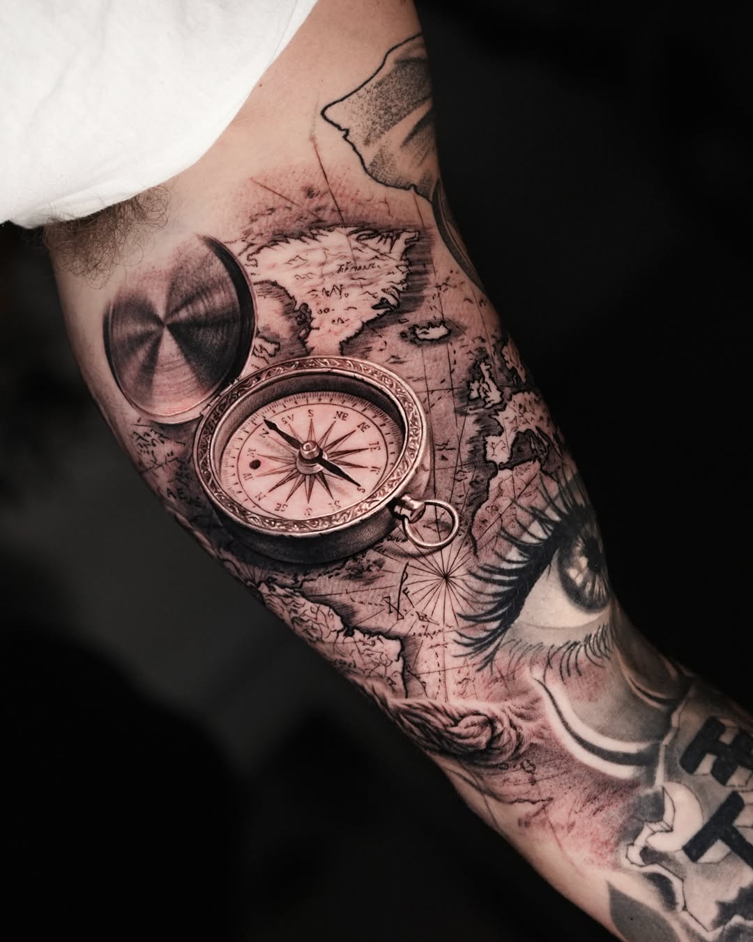 Compass and map surrealism tattoo on the forearm by Gody