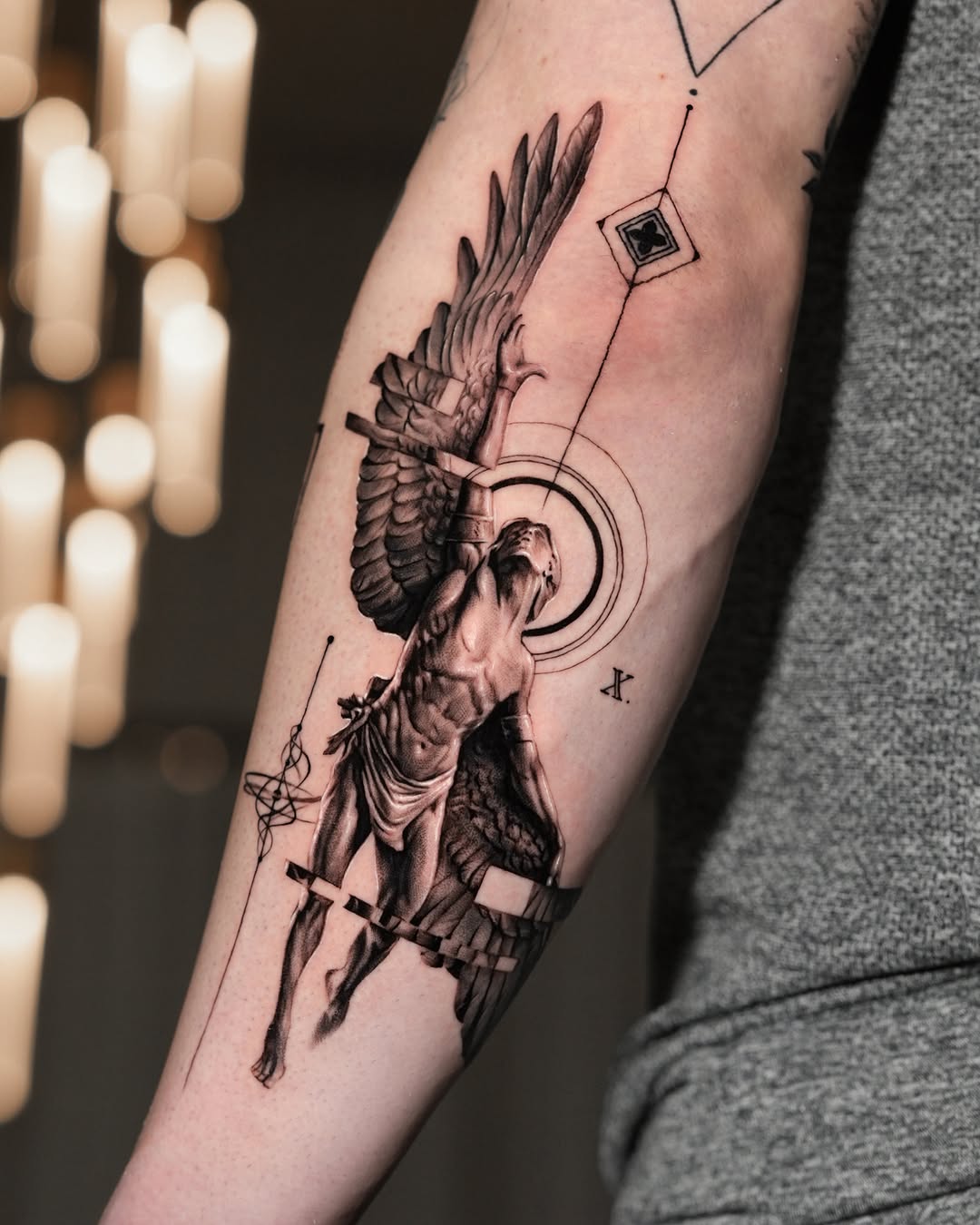 Angelic figure with geometric elements realism tattoo on the forearm by Gody
