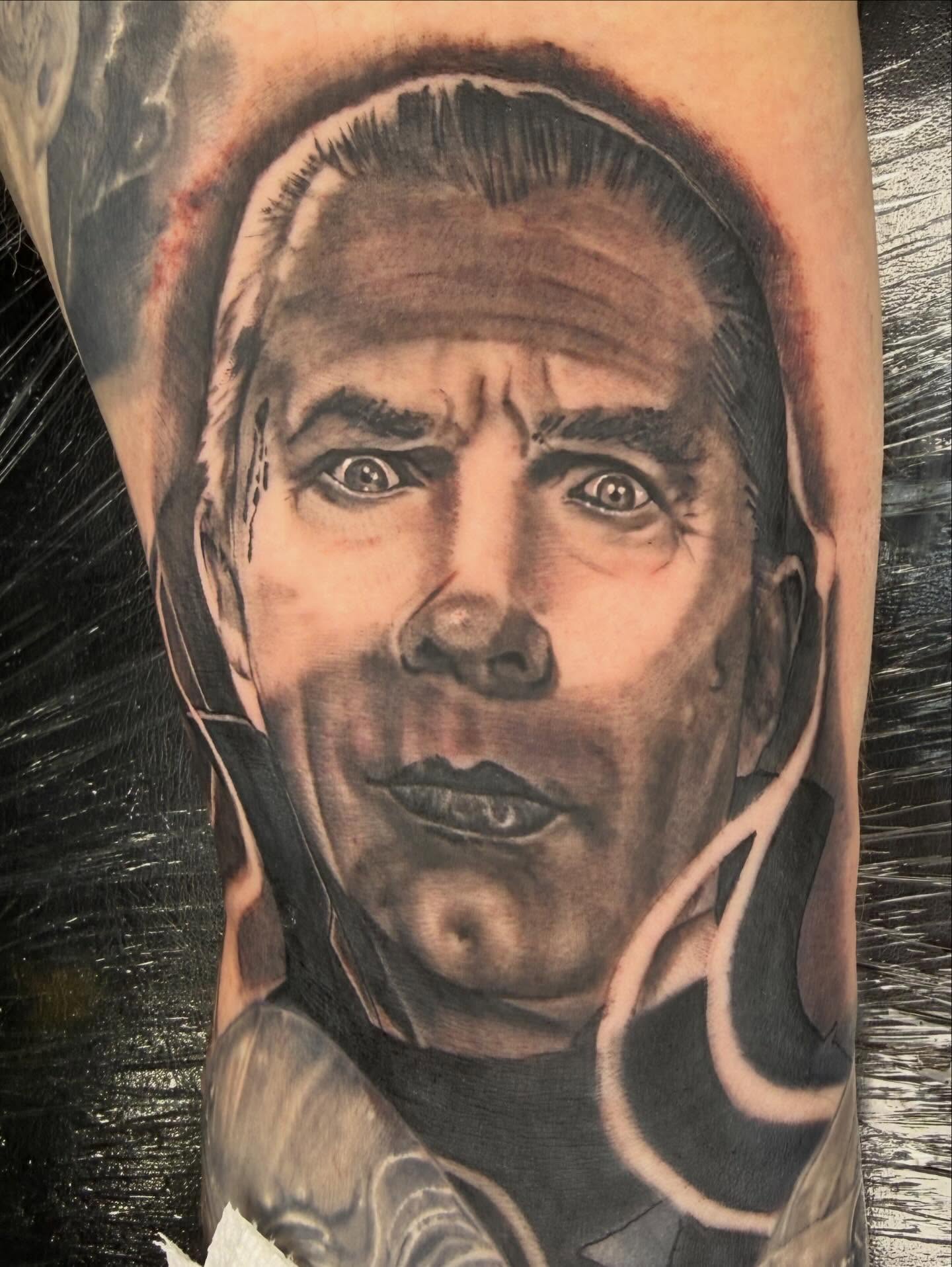 Portrait realism tattoo on the forearm by Frank DeMao