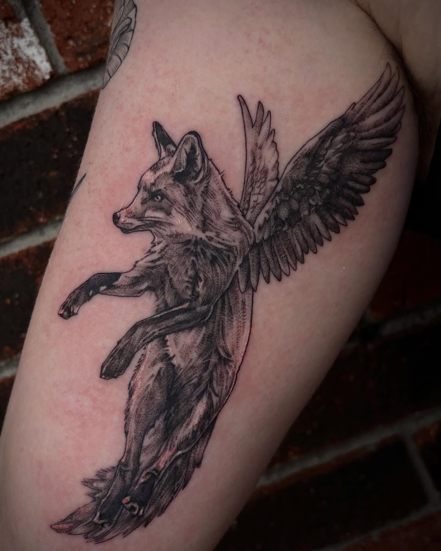 Fox with wings realism tattoo on the forearm by Emily Falkowski