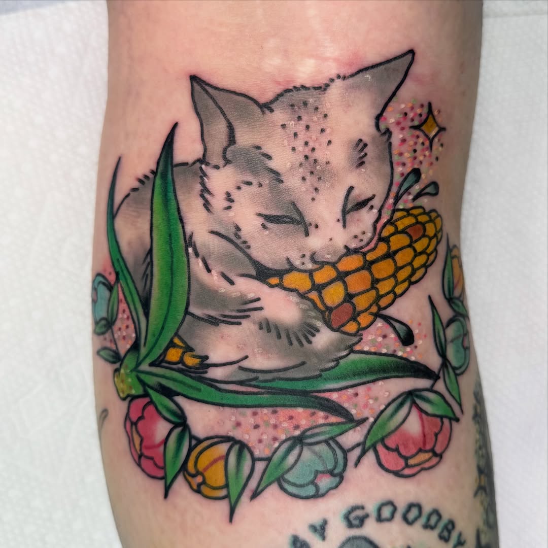 Cat eating corn American traditional tattoo on the forearm by Kurt Brecheis Jr., Malvern, Pennsylvania