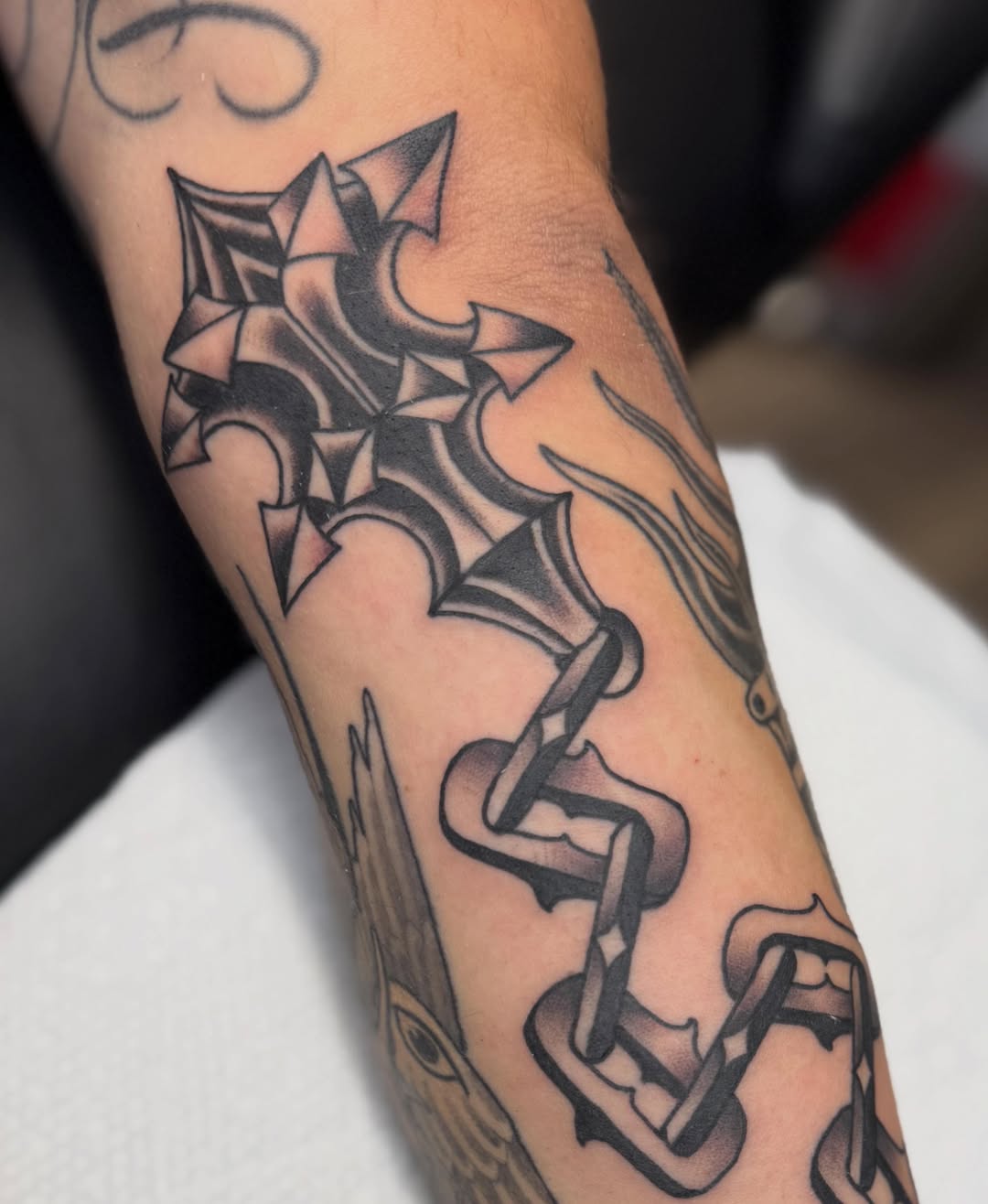 Geometric cross geometric tattoo on the forearm by Chase Martines