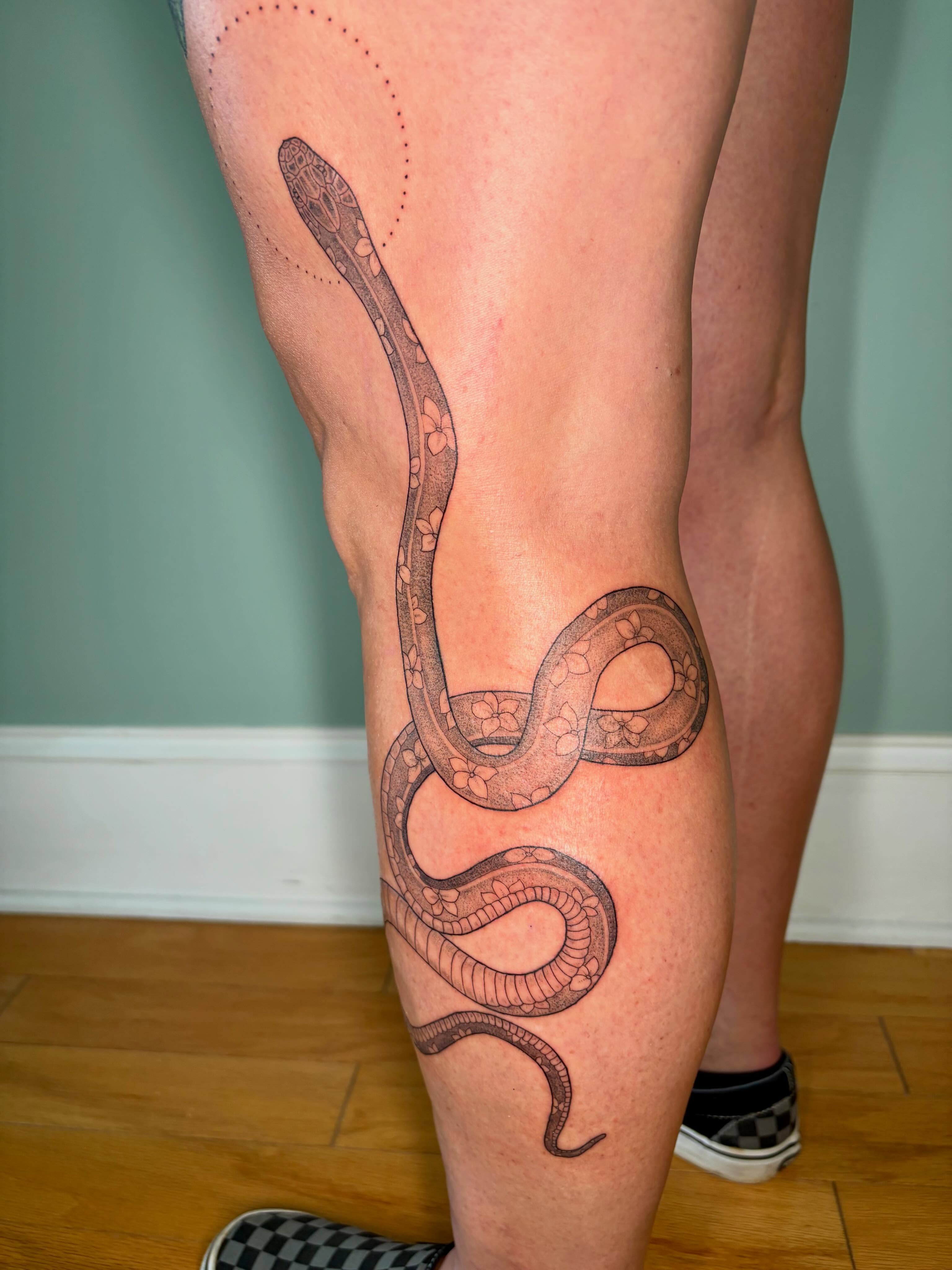 Snake dotwork tattoo on the calf by Sarah Roach