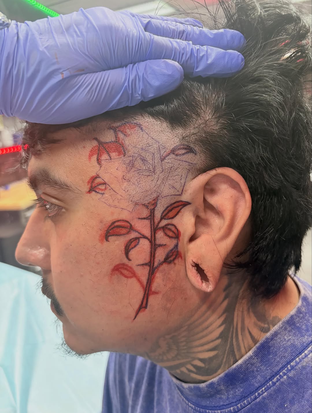Rose stem with leaves tattoo on the head by @inkwitatlas