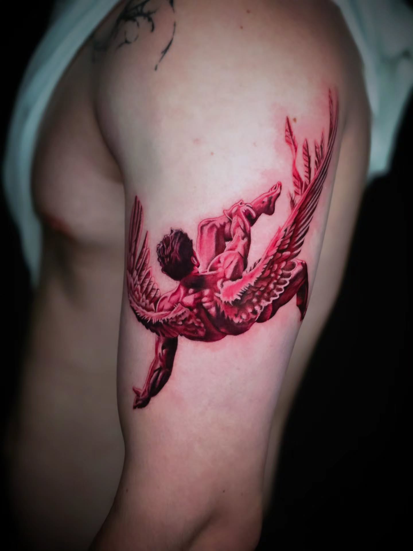 Falling angel realism tattoo on the shoulder by Jake Barney