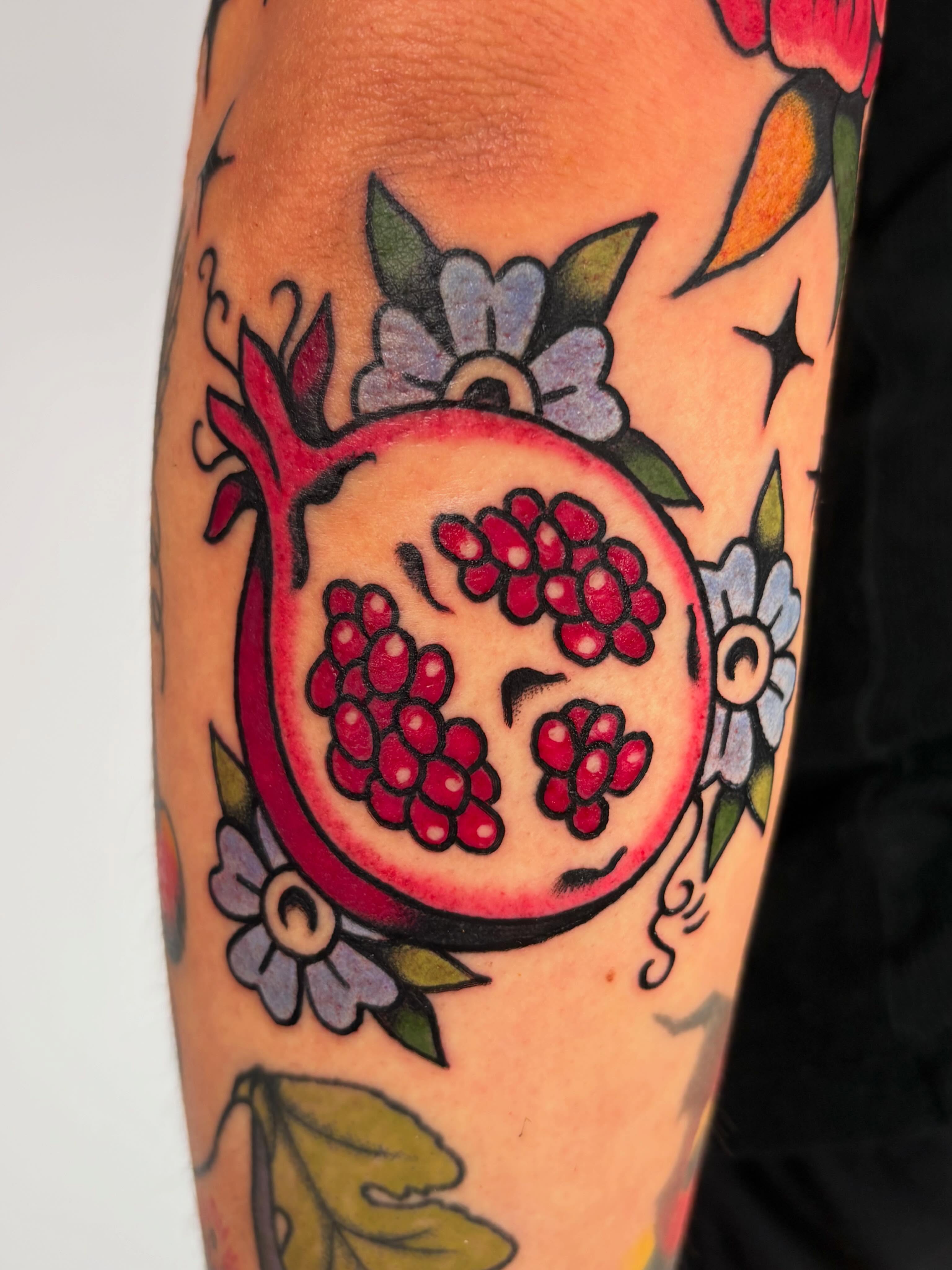 Pomegranate American traditional tattoo on the forearm by Lorelei