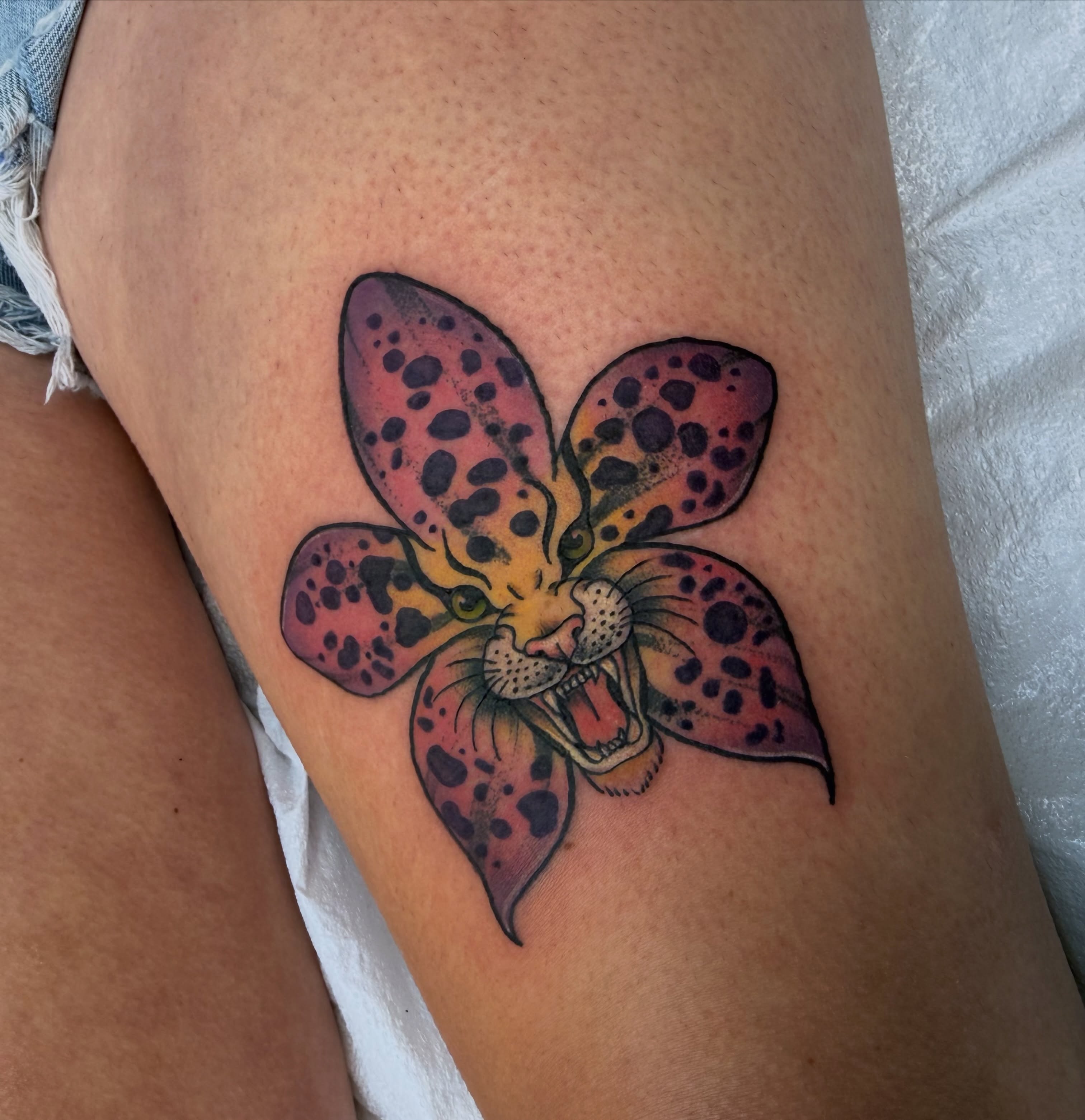 Panther flower trash polka tattoo on the thigh by Luna Faye