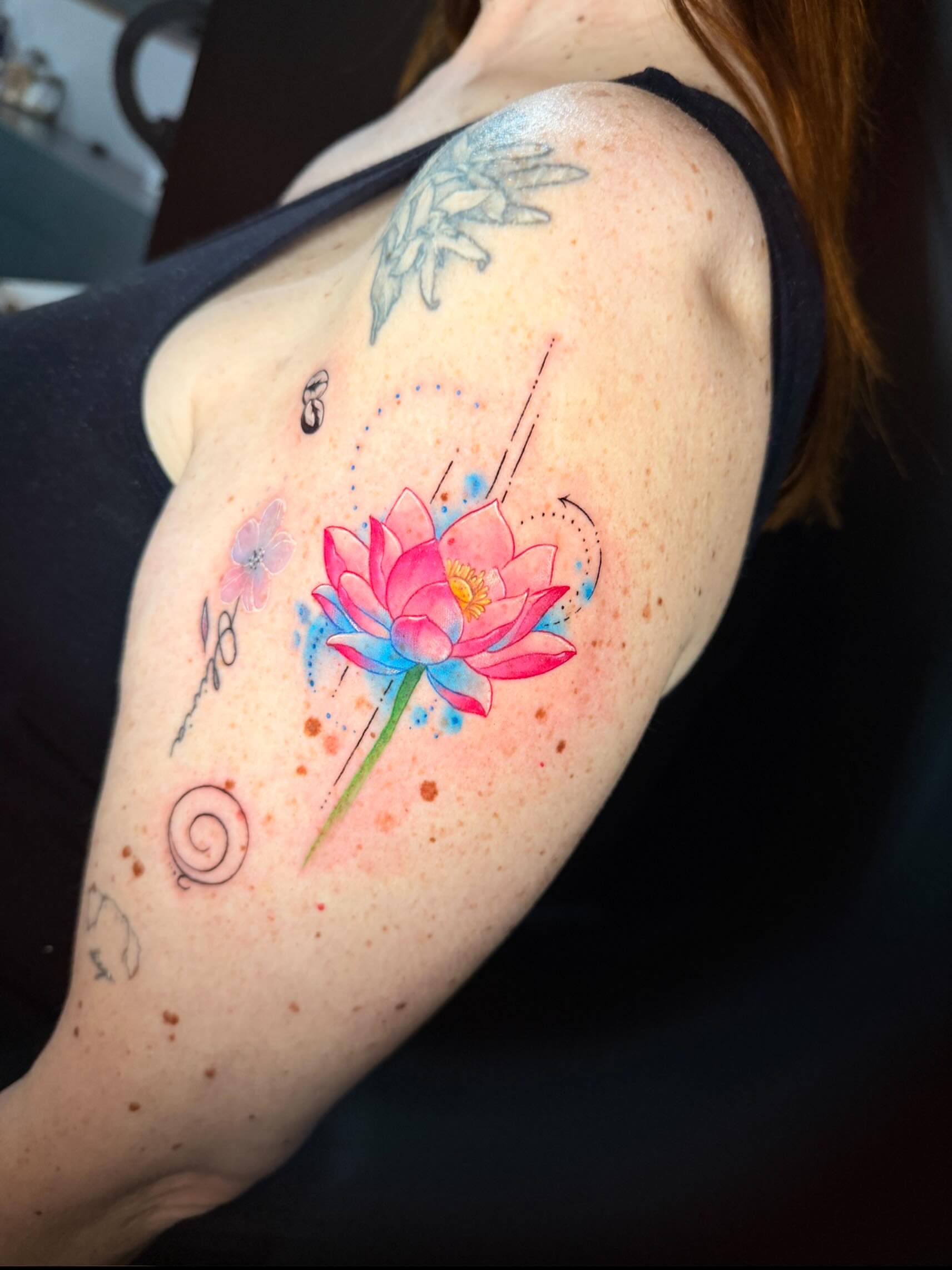 Lotus flower watercolor tattoo on the shoulder by Violet Michelle Williams, Charlotte, North Carolina