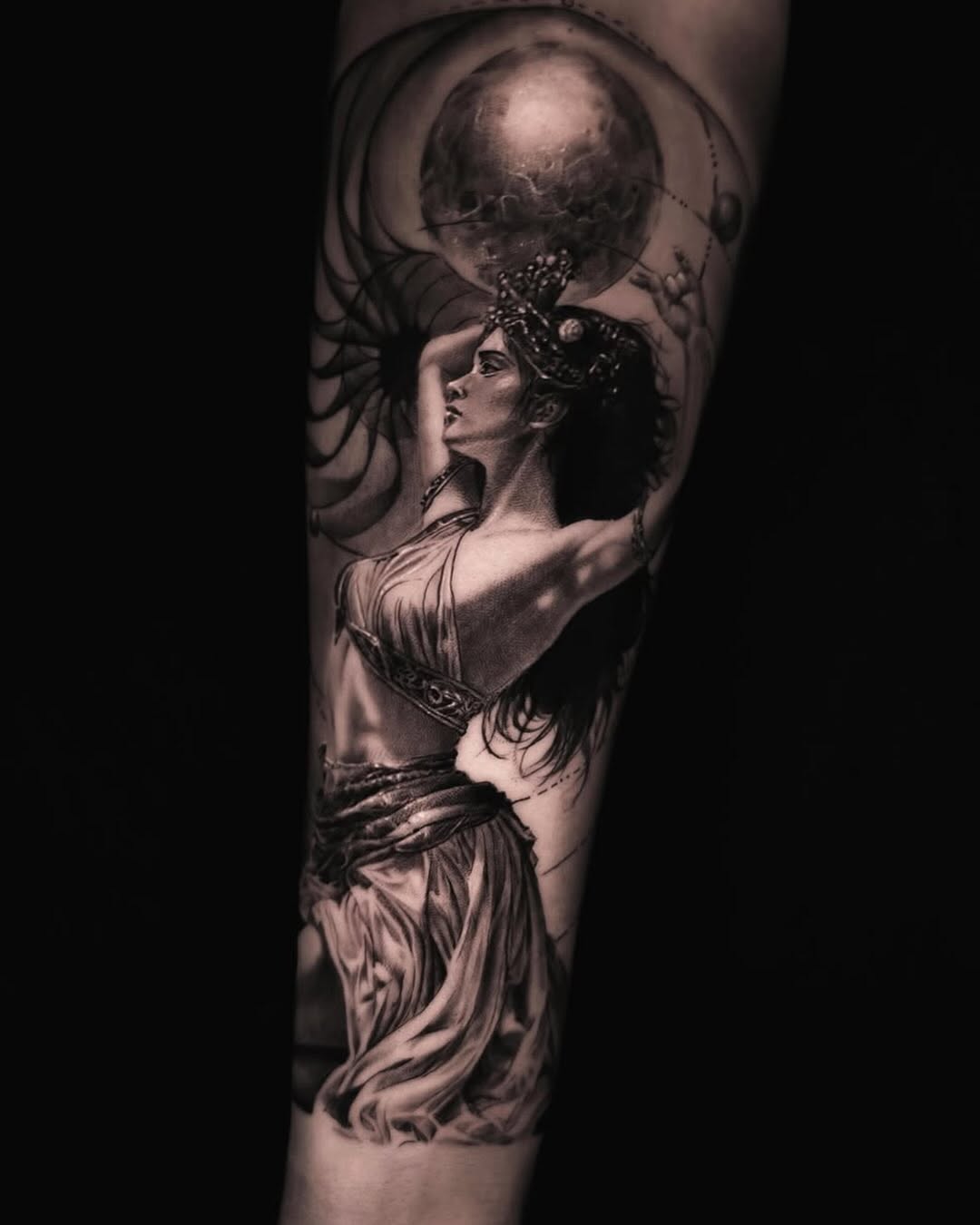 Woman with moon and spiral realism tattoo on the forearm by Pitasso tattoo black and grey