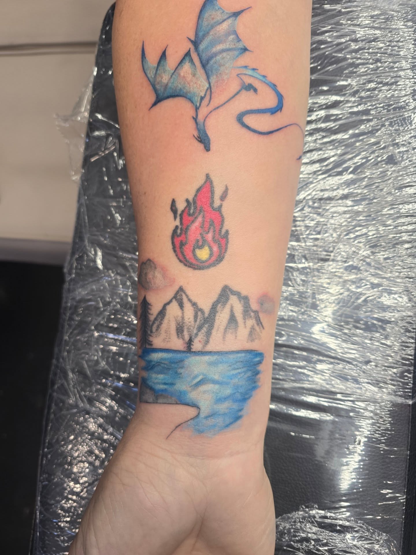 Dragon, fire, mountains, lake dotwork tattoo on the forearm by Maddox Kitson🕷