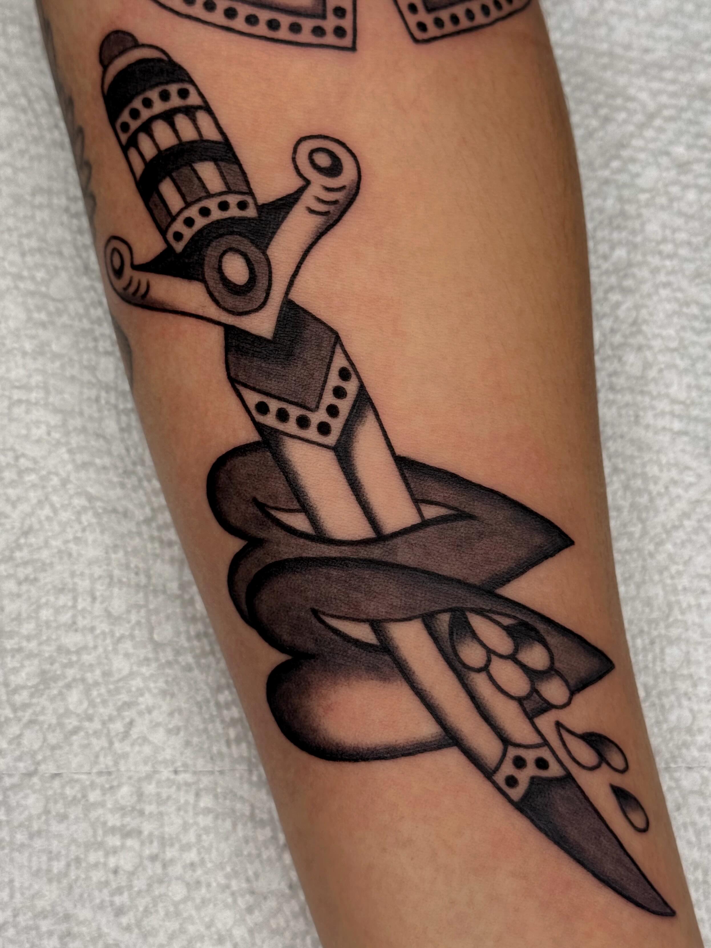 Snake and dagger American traditional tattoo on the forearm by Bridgette Carberry