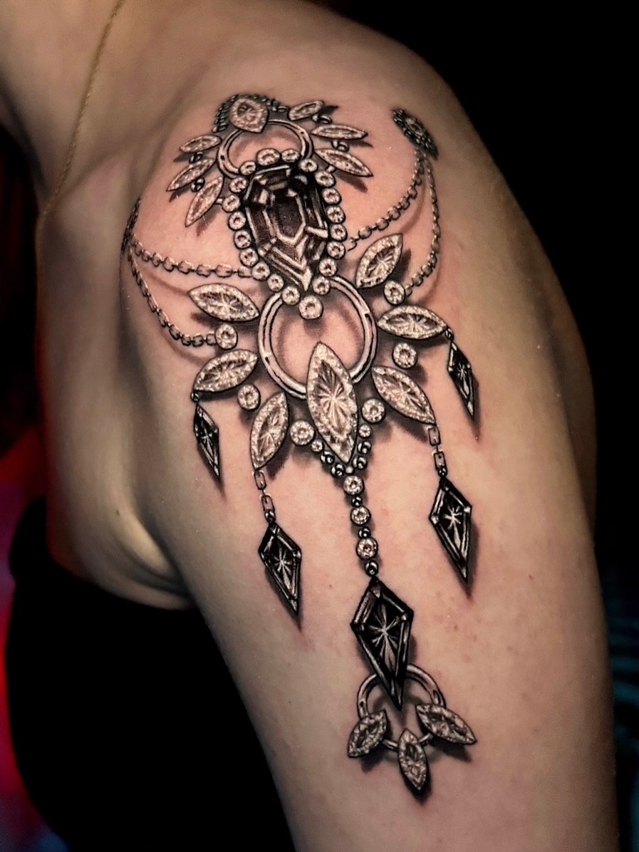 Tattoo by @amberstrangetattoos โ realism, black_and_grey
