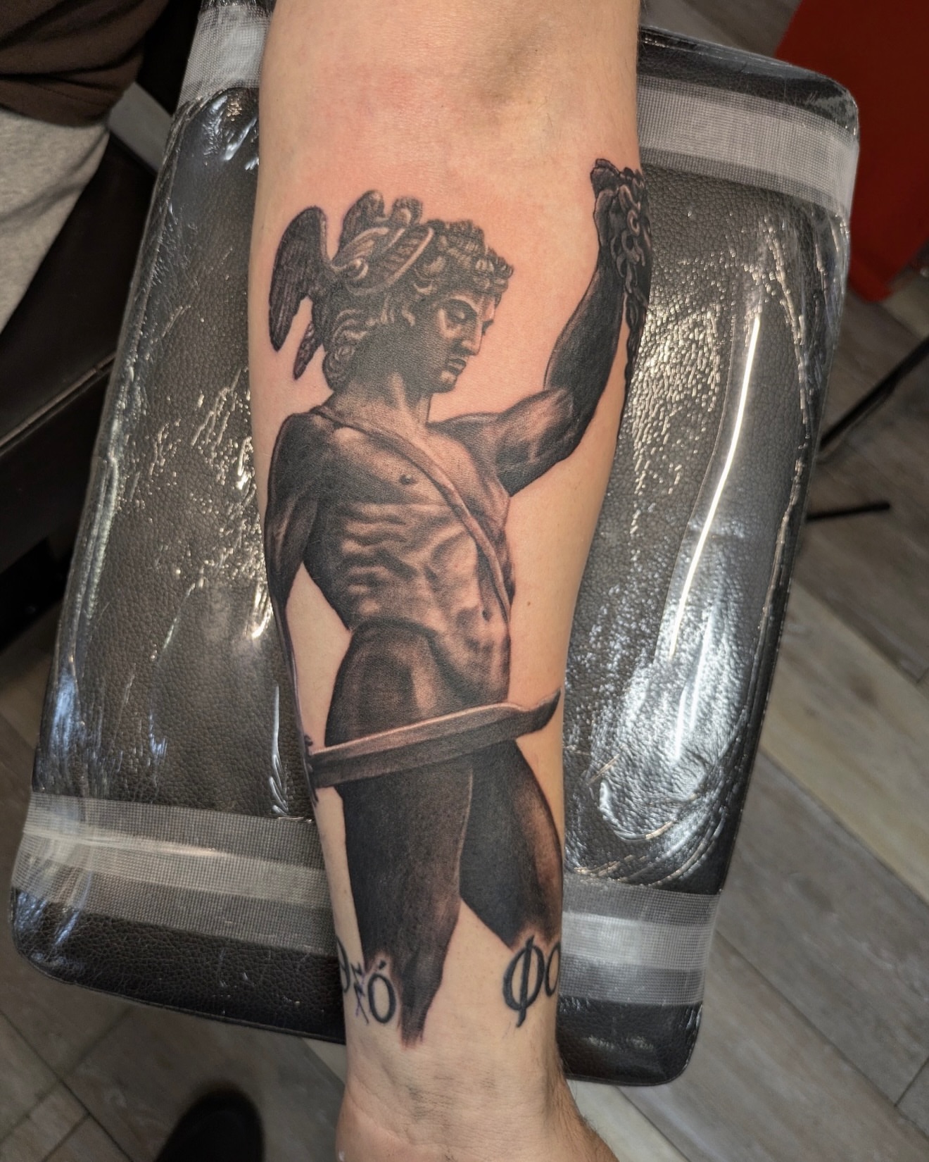 Medusa head black and grey tattoo on the forearm by Buddy K.