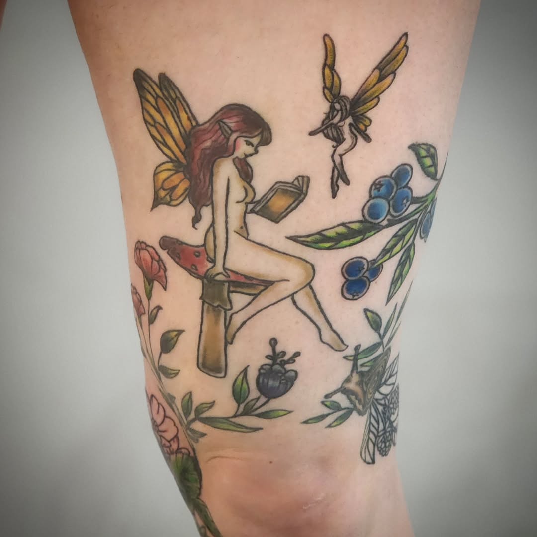Fairy reading on mushroom with berries neo-traditional tattoo on the forearm by Anntonietta Borzacchiello